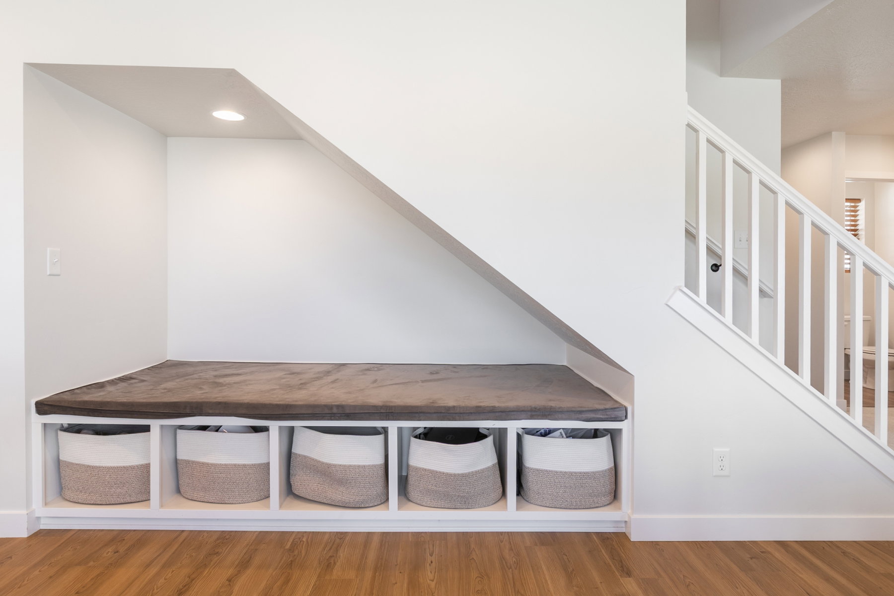 Upgrade - under-stair built-in bench with integrated storage. Upgraded railing.