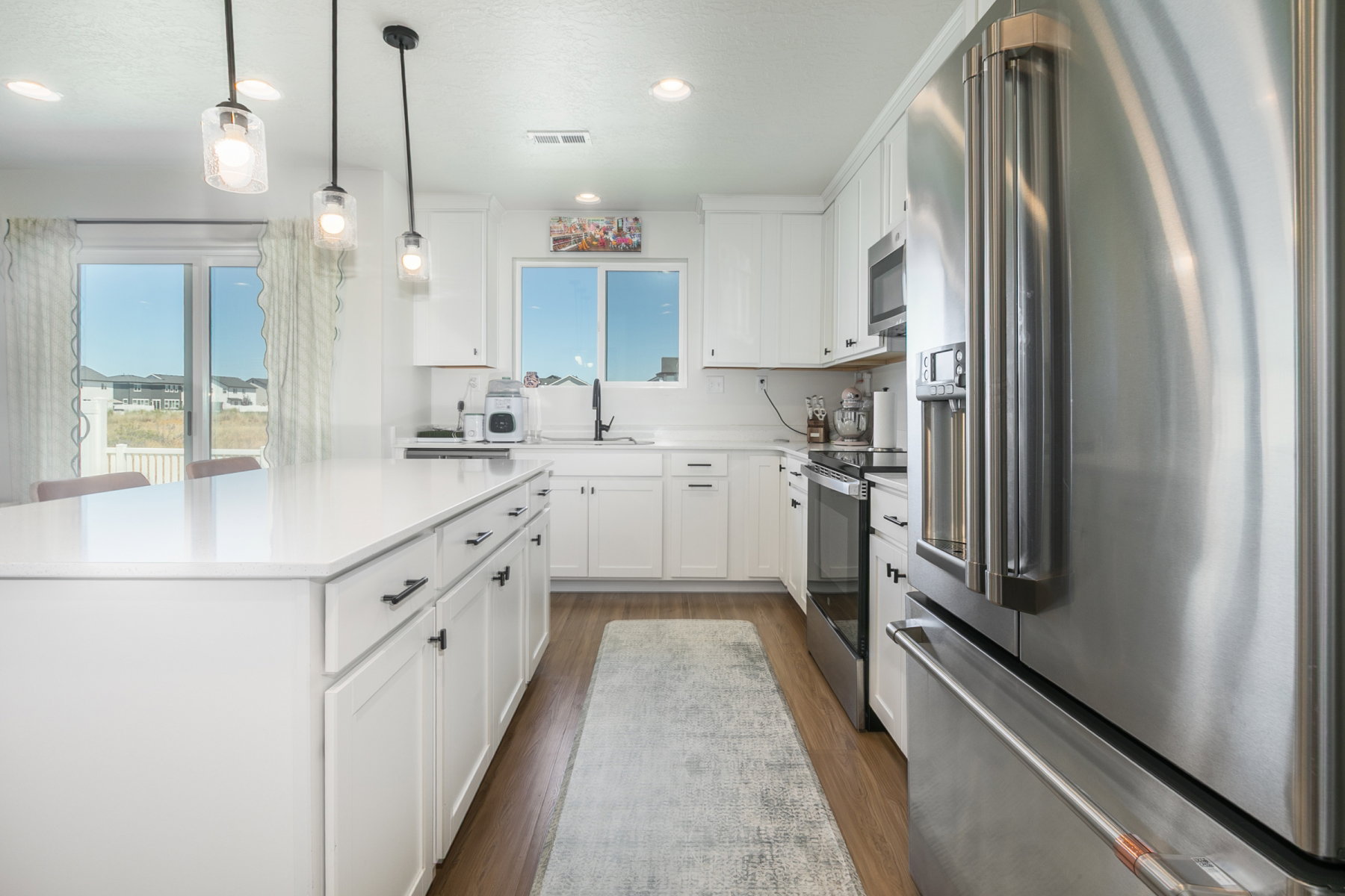Kitchen upgrades include: 42" cabinets, lighting, VoiceIQ faucet, quartz counter tops, gas line for stove. Refrigerator included.