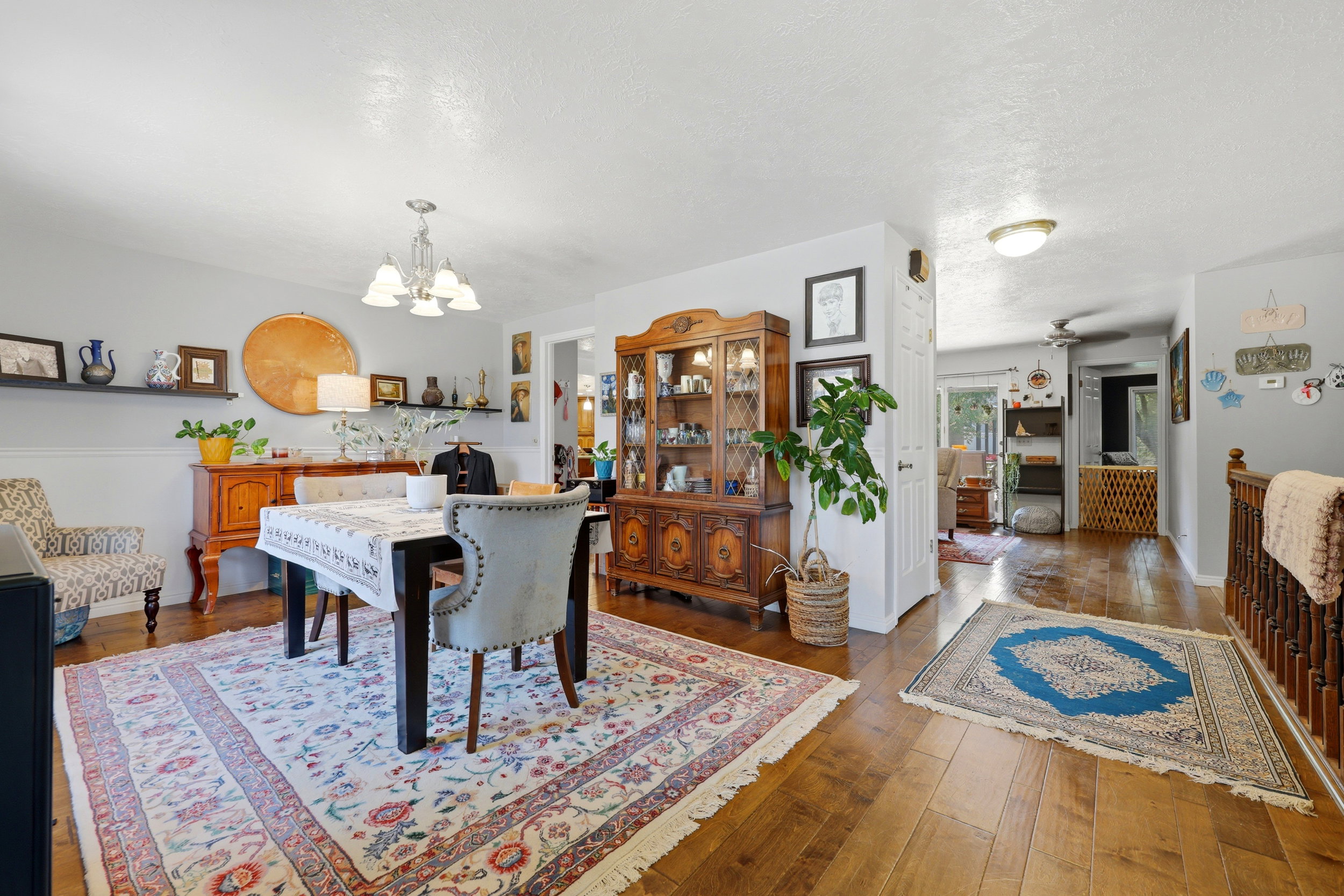 Dining area featuring wood-finish flooring and a contemporary chandelier