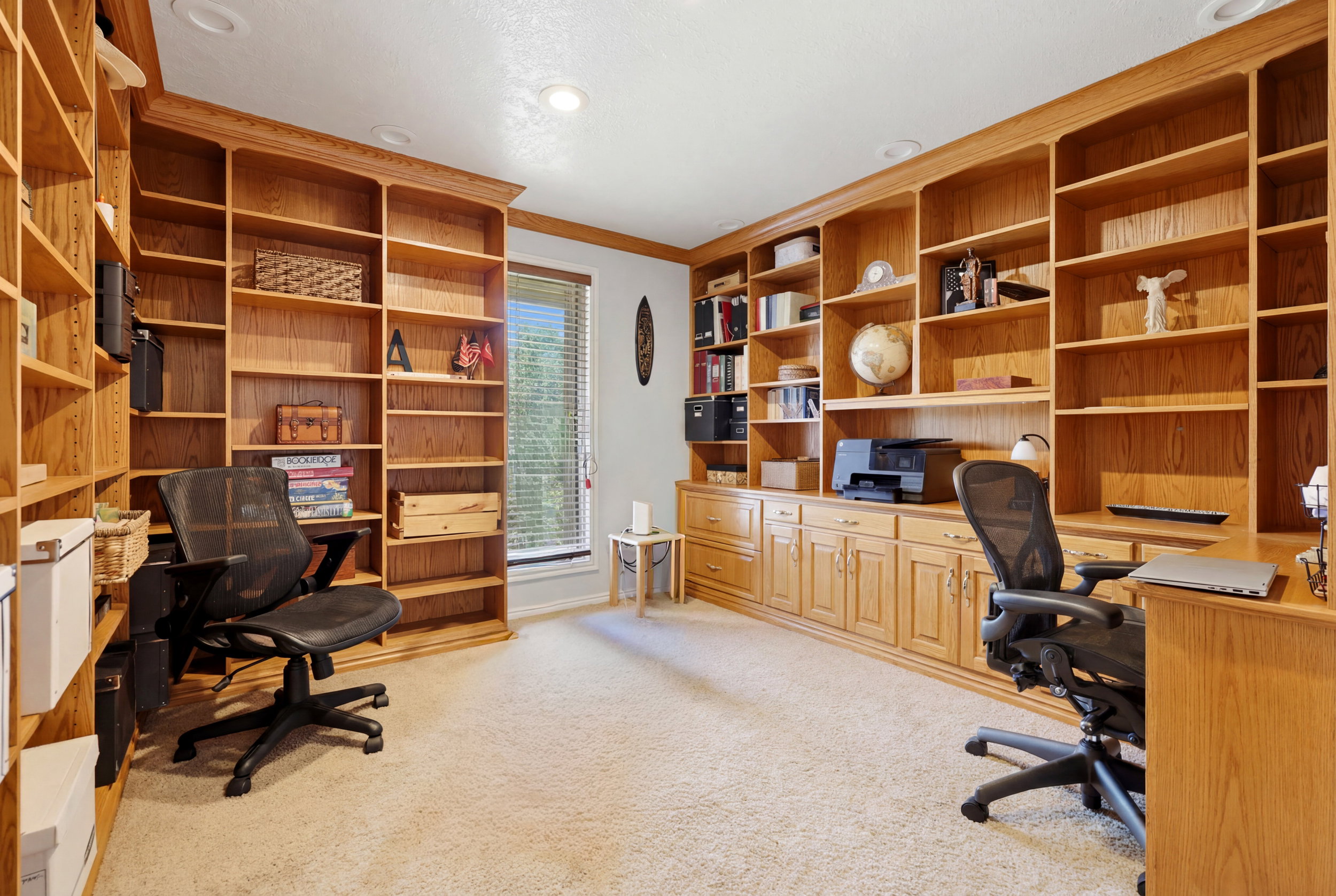 Room featuring extensive built-in wooden shelving and cabinetry