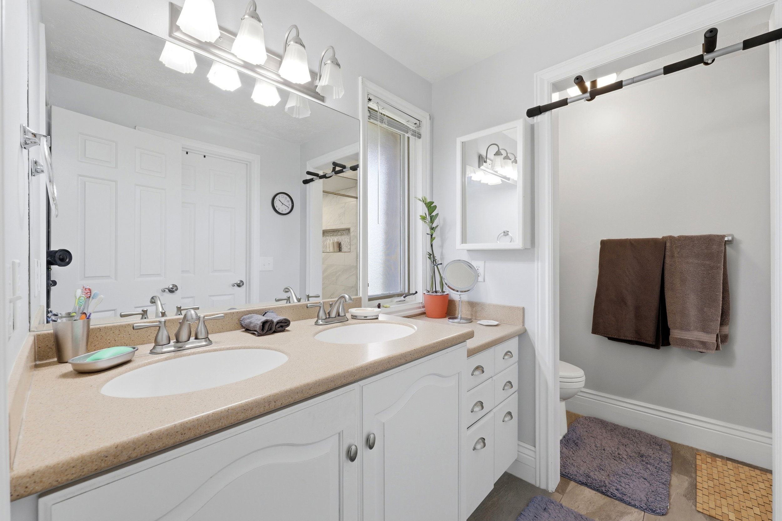 Spacious bathroom with a dual vanity featuring two undermount sinks and a light-toned countertop