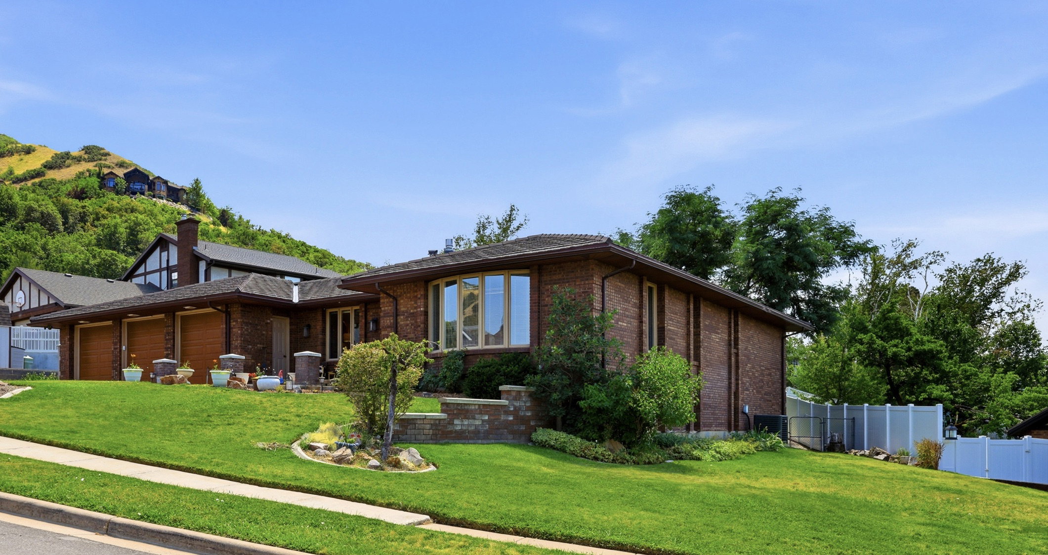 Brick exterior residence with a bay window and multi-car garage