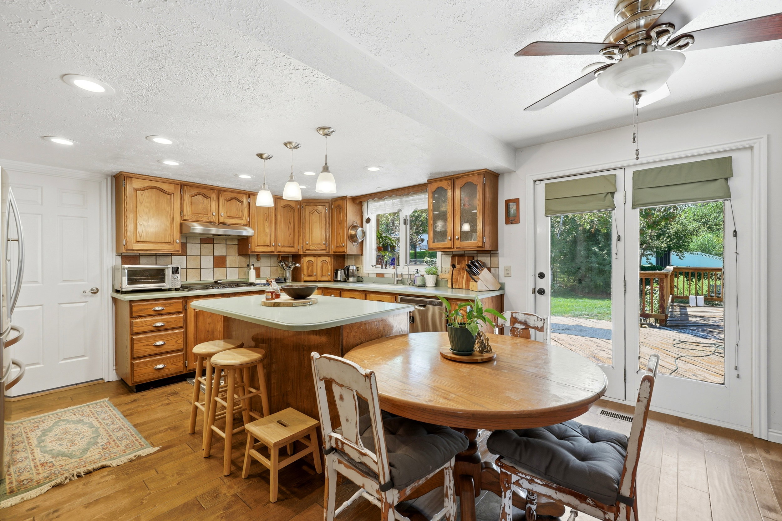 Kitchen featuring wood-finish flooring, recessed lighting, and a center island with pendant lights