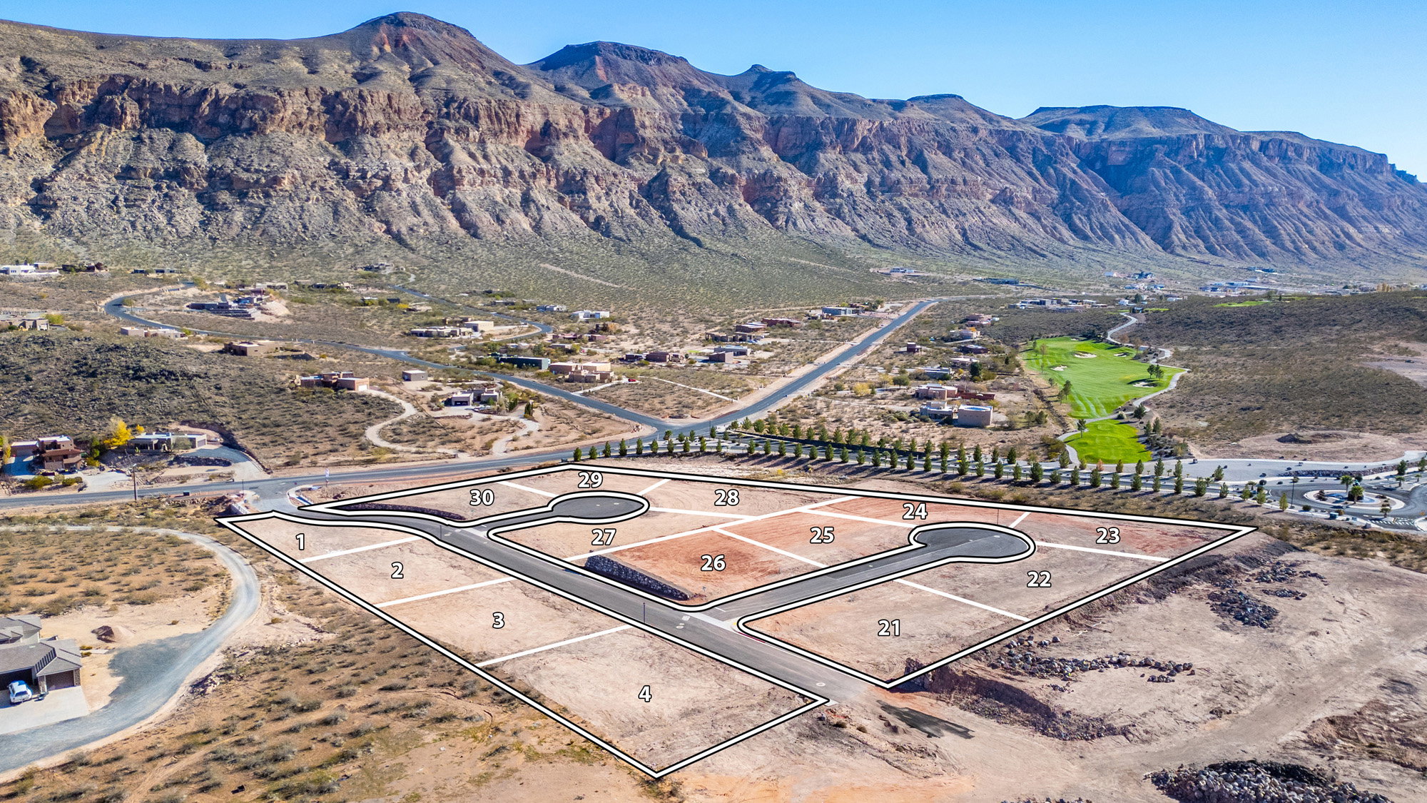 Aerial perspective of a development with individual lots outlined, featuring paved roads and cul-de-sacs