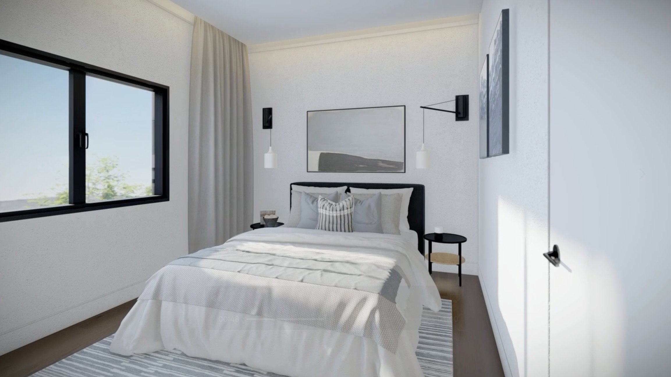 Bright room featuring a large window with black framing, wood-finish flooring, and white walls