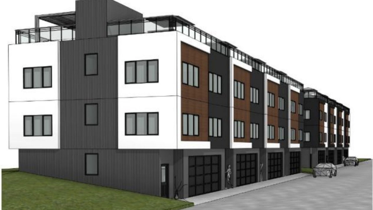 Contemporary multi-level townhome featuring a mixed-material facade with white, brown, and dark gray siding