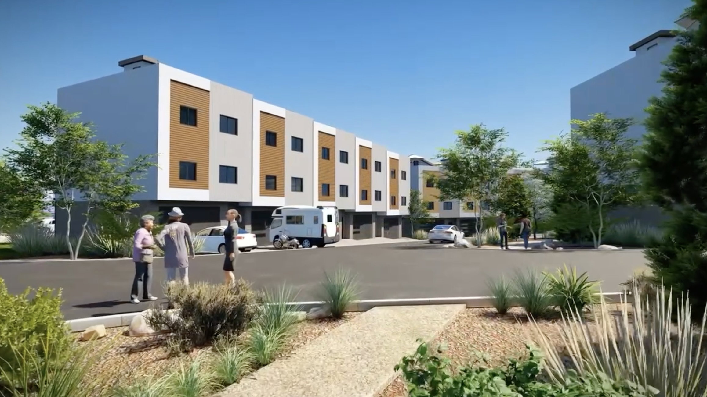 Modern townhome complex featuring multi-story units with contrasting exterior finishes