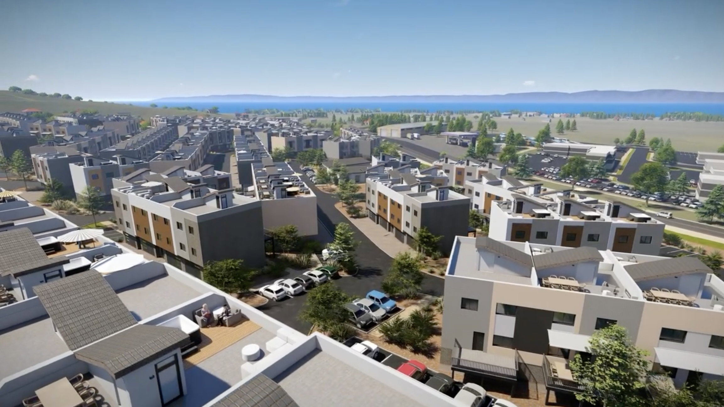 Contemporary residential development featuring multi-story units, flat and pitched rooflines, and a varied facade of light and dark finishes
