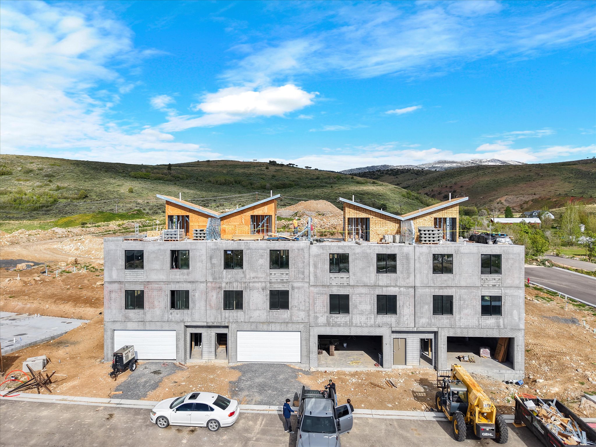 Modern multi-level development featuring concrete panel construction and a distinctive butterfly roofline