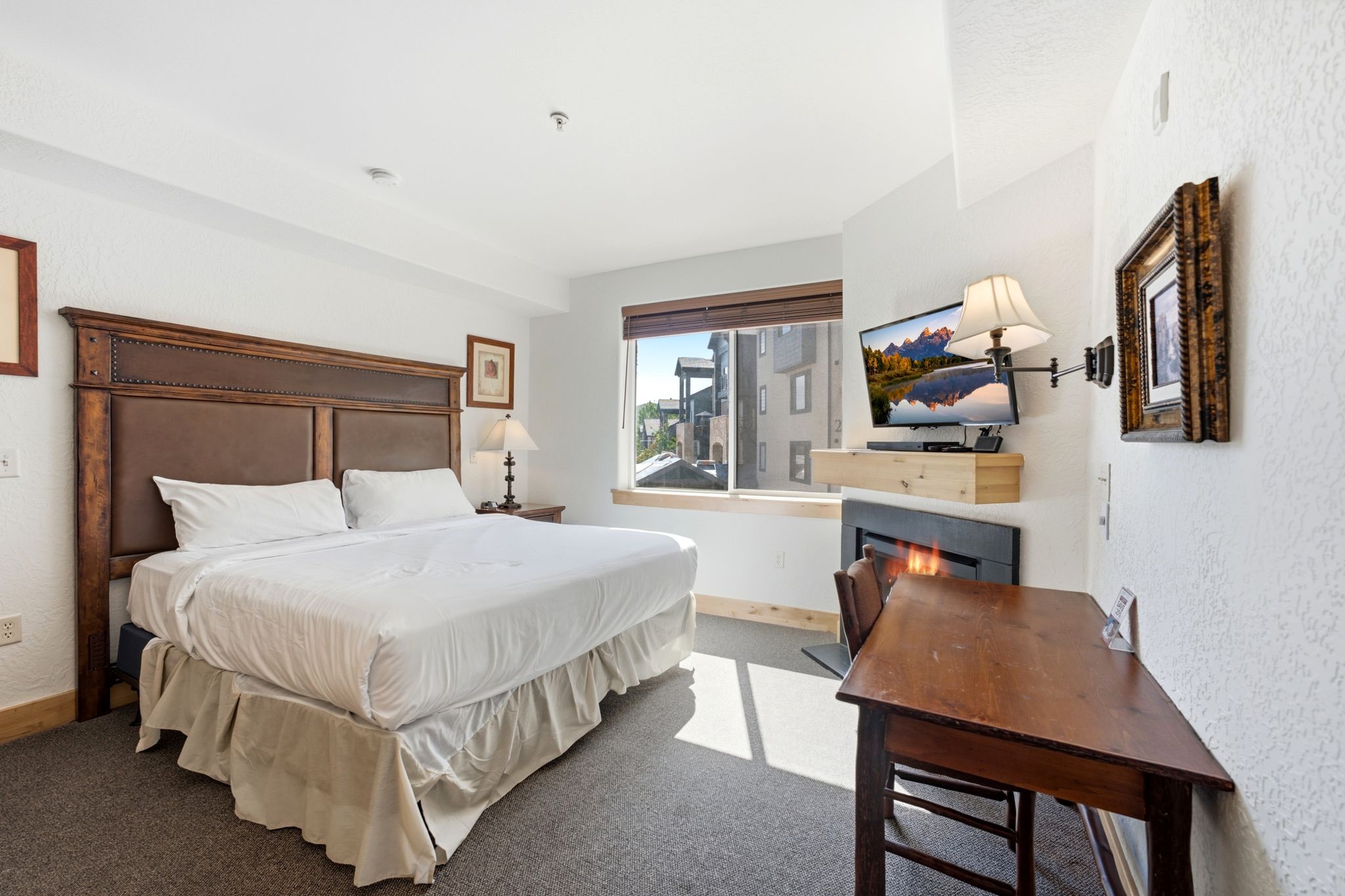 Spacious room featuring a large window, built-in fireplace, and textured wall finishes