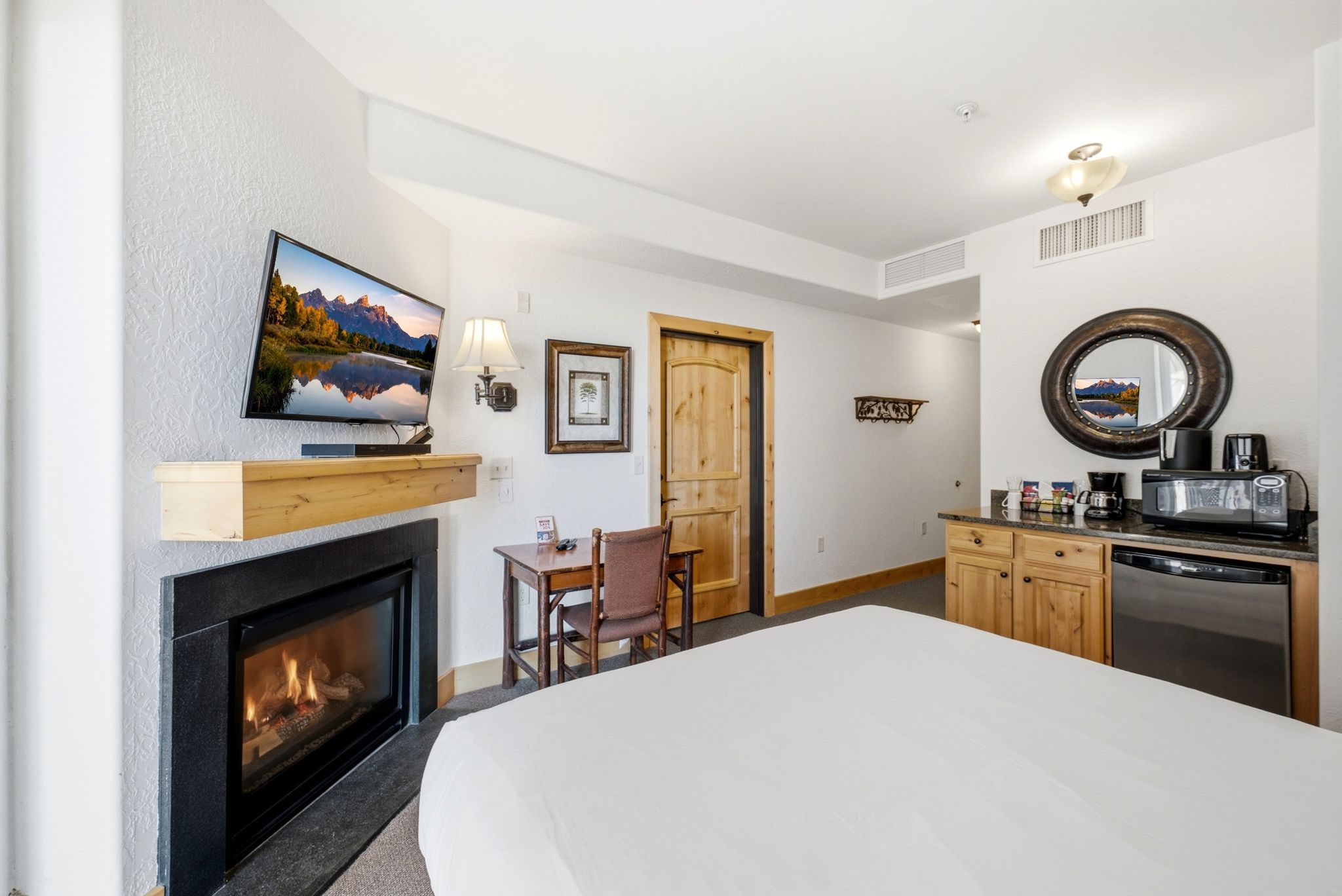 Built-in fireplace with black surround and wood mantel