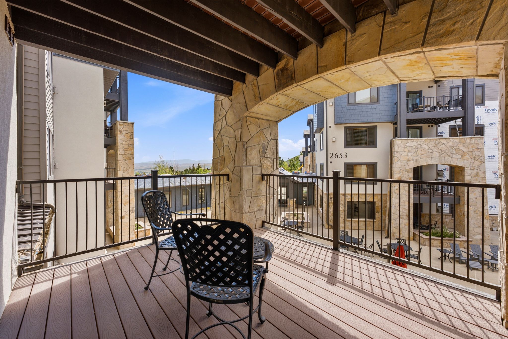 Covered balcony featuring stone archways and columns