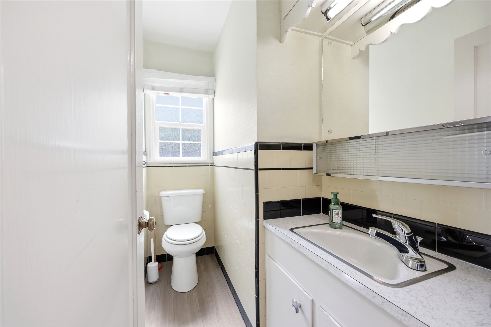 Bathroom vanity with integrated sink, chrome faucet, and patterned laminate countertop