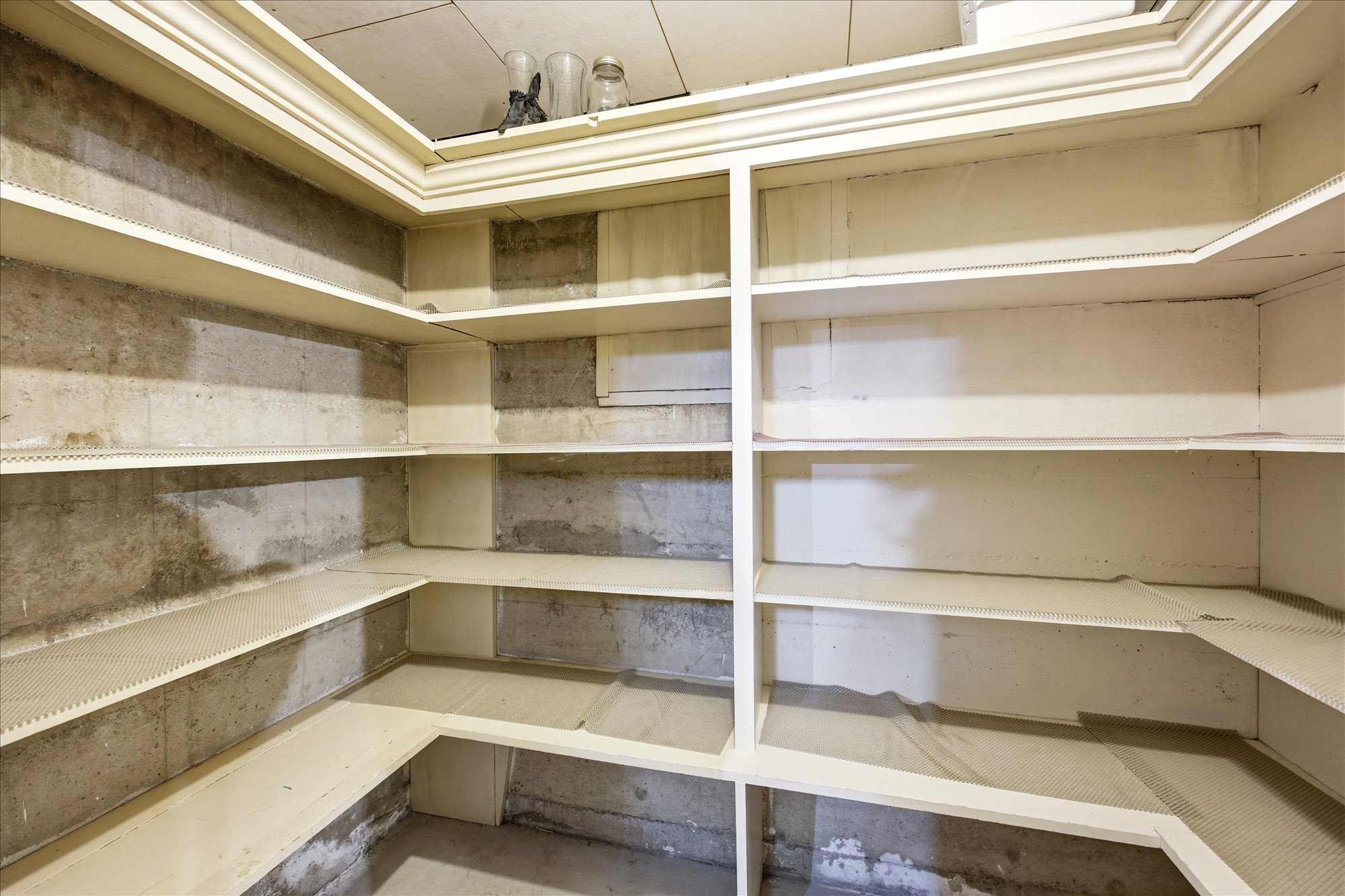 Built-in shelving unit providing extensive storage, finished with crown molding detail
