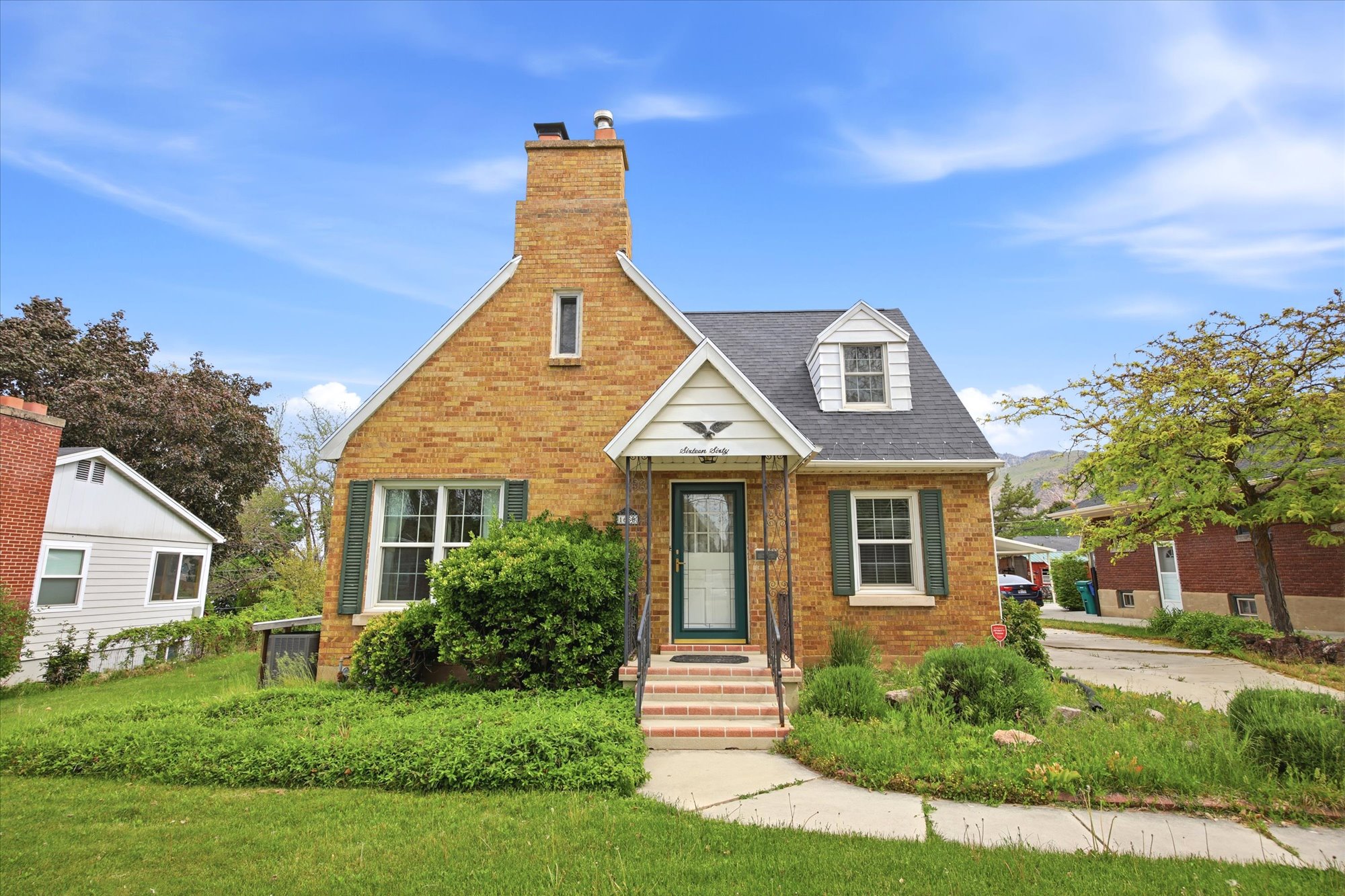 Brick exterior with a prominent front-facing gable and dormer windows