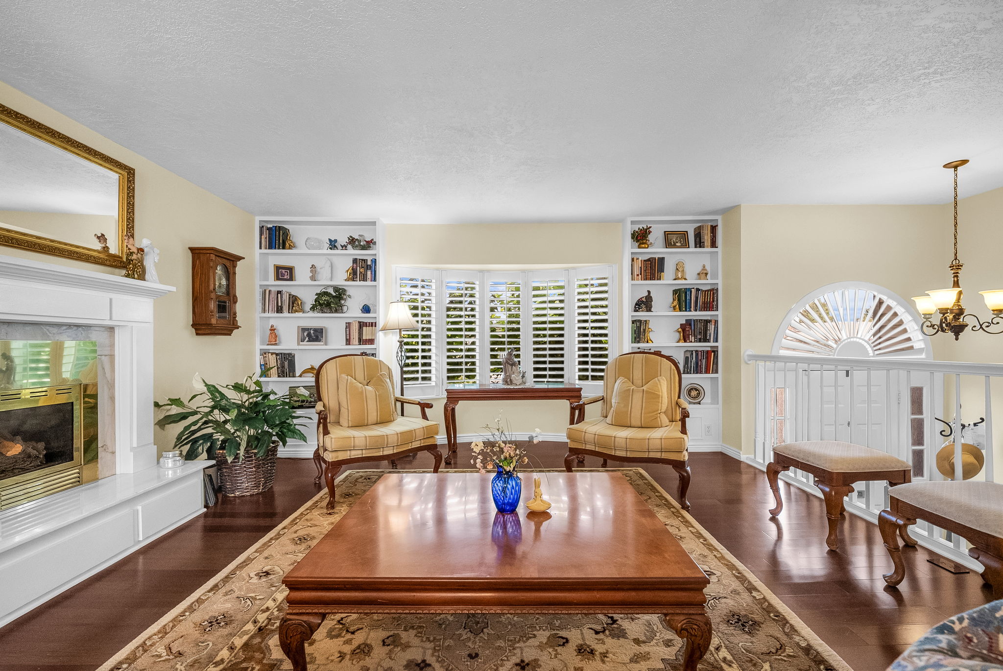 Lovely fliving room with built-in bookshelves.  Planations shutters are throughout the house!