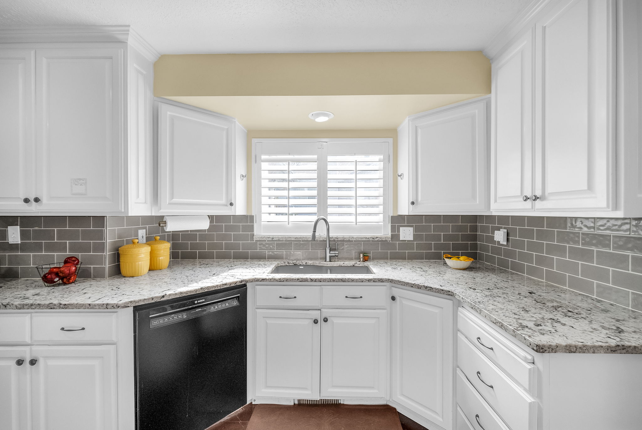 Granite counters and gray subway tile backsplash to accent!