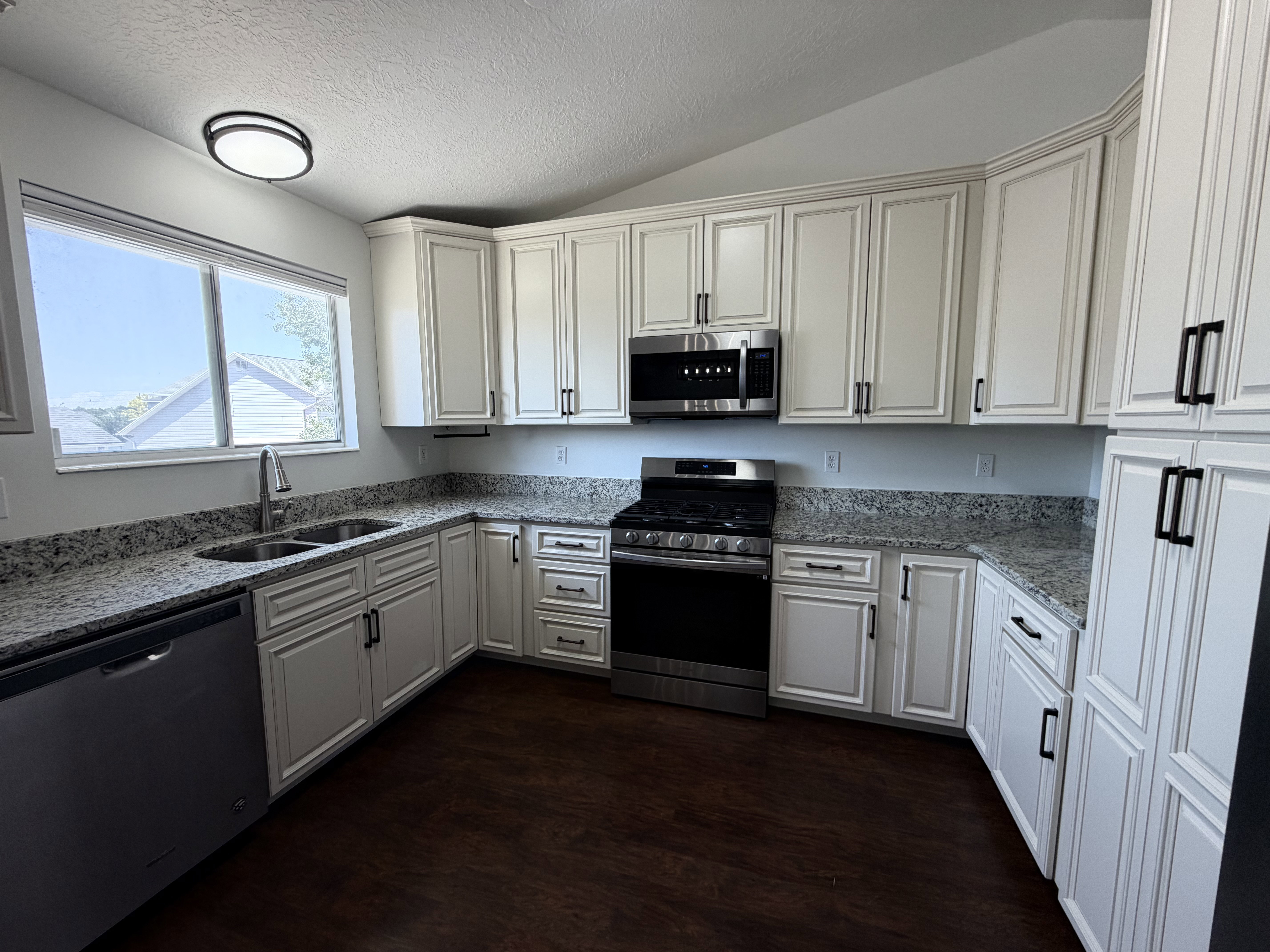 Well-appointed kitchen featuring a stainless steel gas range, microwave, and dishwasher