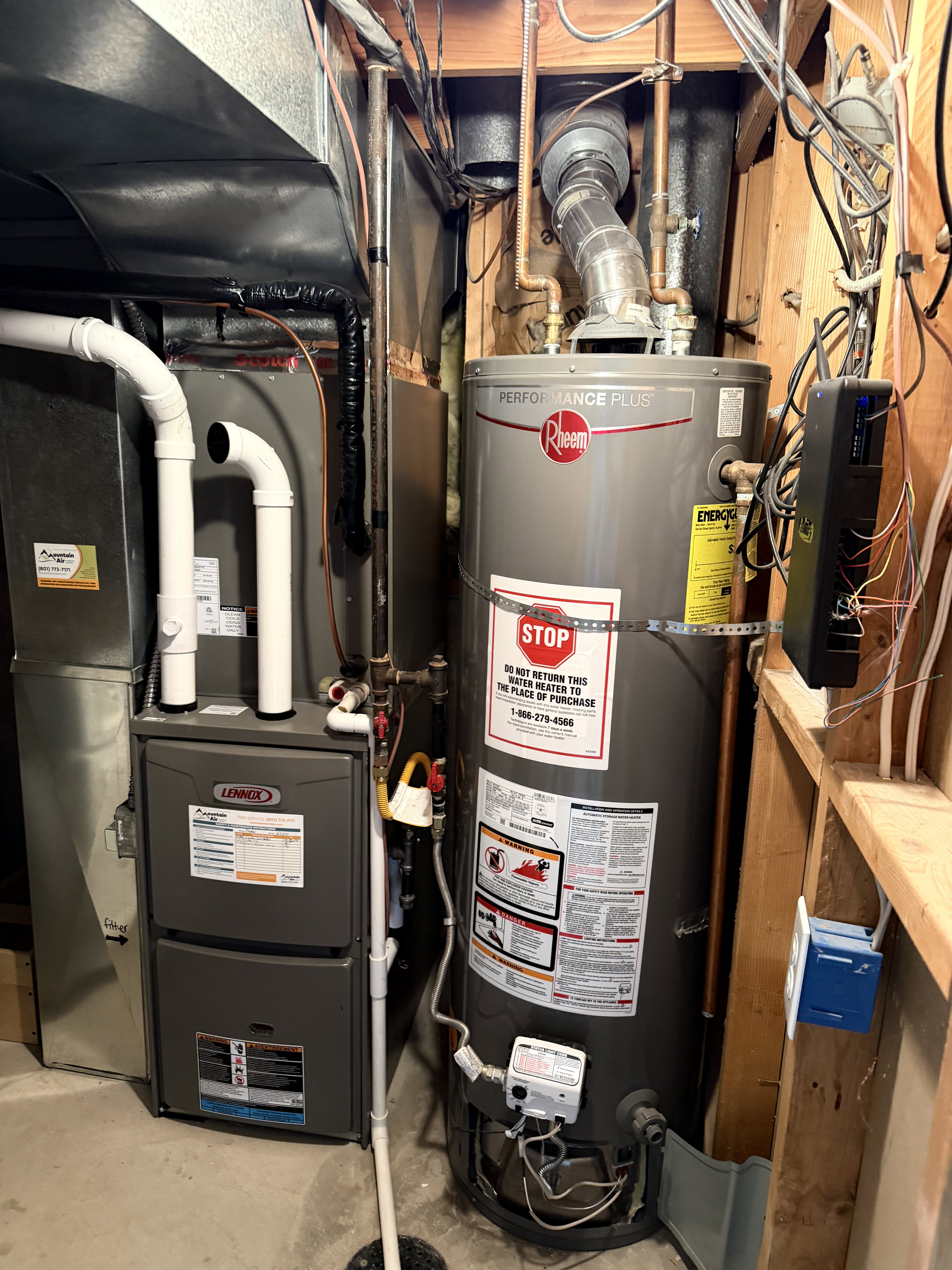 Utility area featuring a Lennox furnace and Rheem Performance Plus water heater