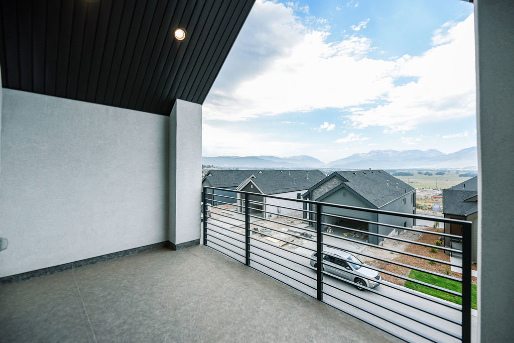 Balcony with modern horizontal railing overlooking mountainous terrain