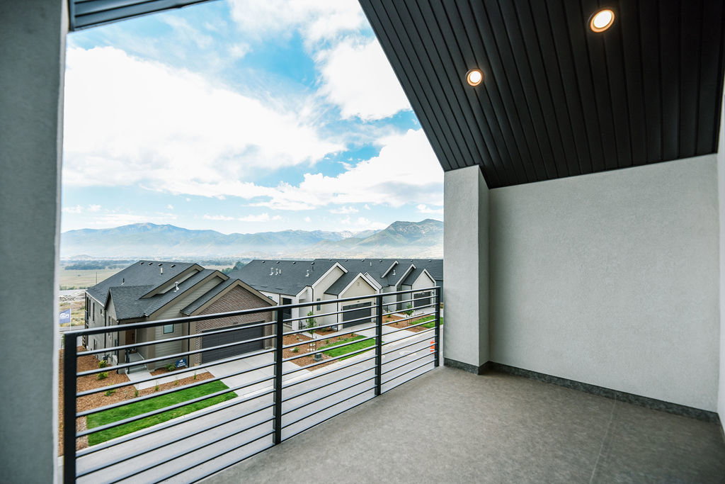 Balcony with a mountain backdrop and horizontal metal railings