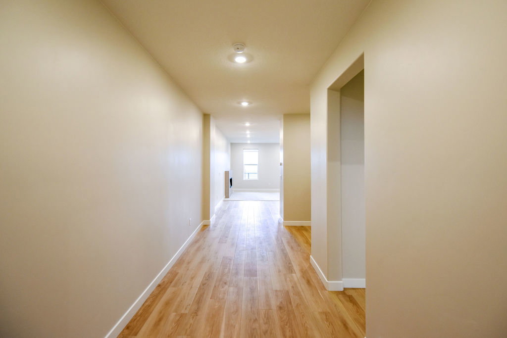 Hallway featuring wood-finish flooring, recessed lighting, and neutral wall tones