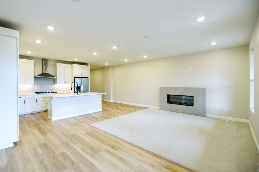 Open-concept living area featuring a modern kitchen and living room