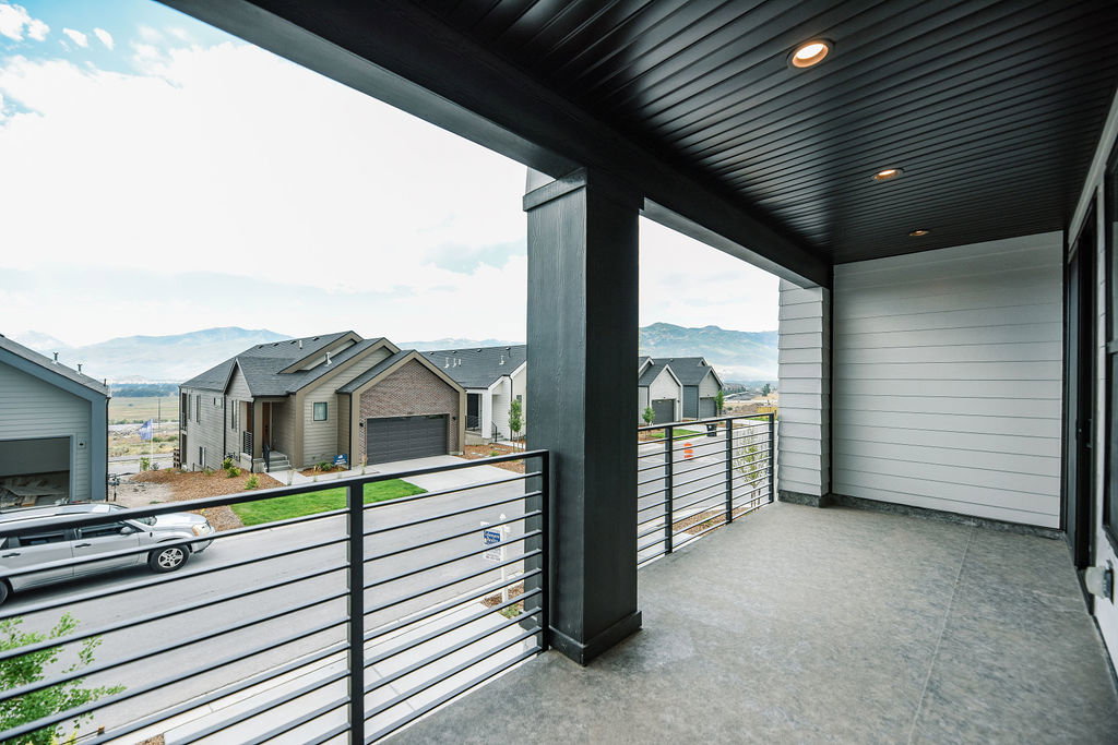 Spacious covered balcony featuring recessed lighting, a dark wood-finish ceiling, and horizontal metal railings