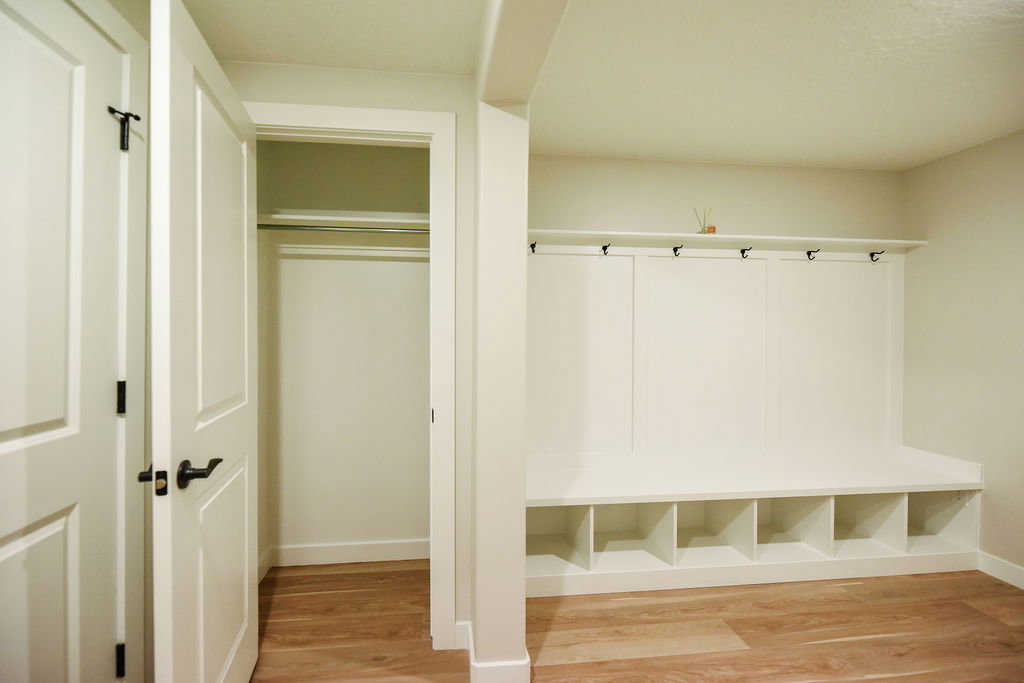 Built-in mudroom bench with open storage cubbies and coat hooks