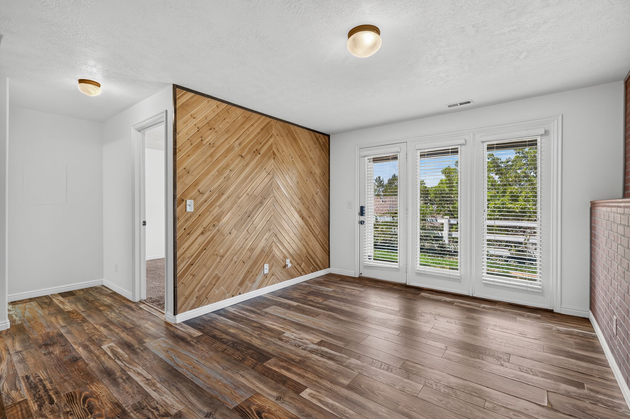 Accent wall featuring a chevron wood-finish pattern