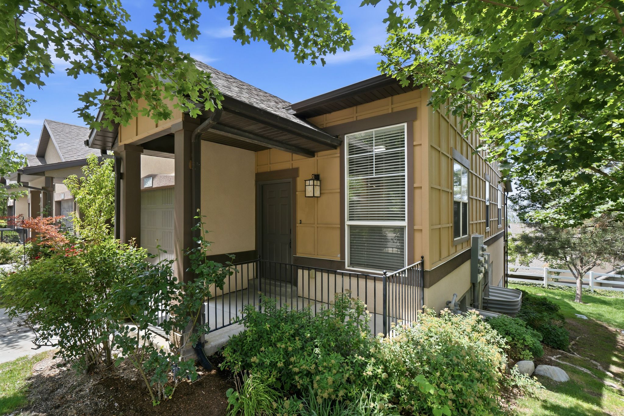 Contemporary exterior with tan siding and dark trim