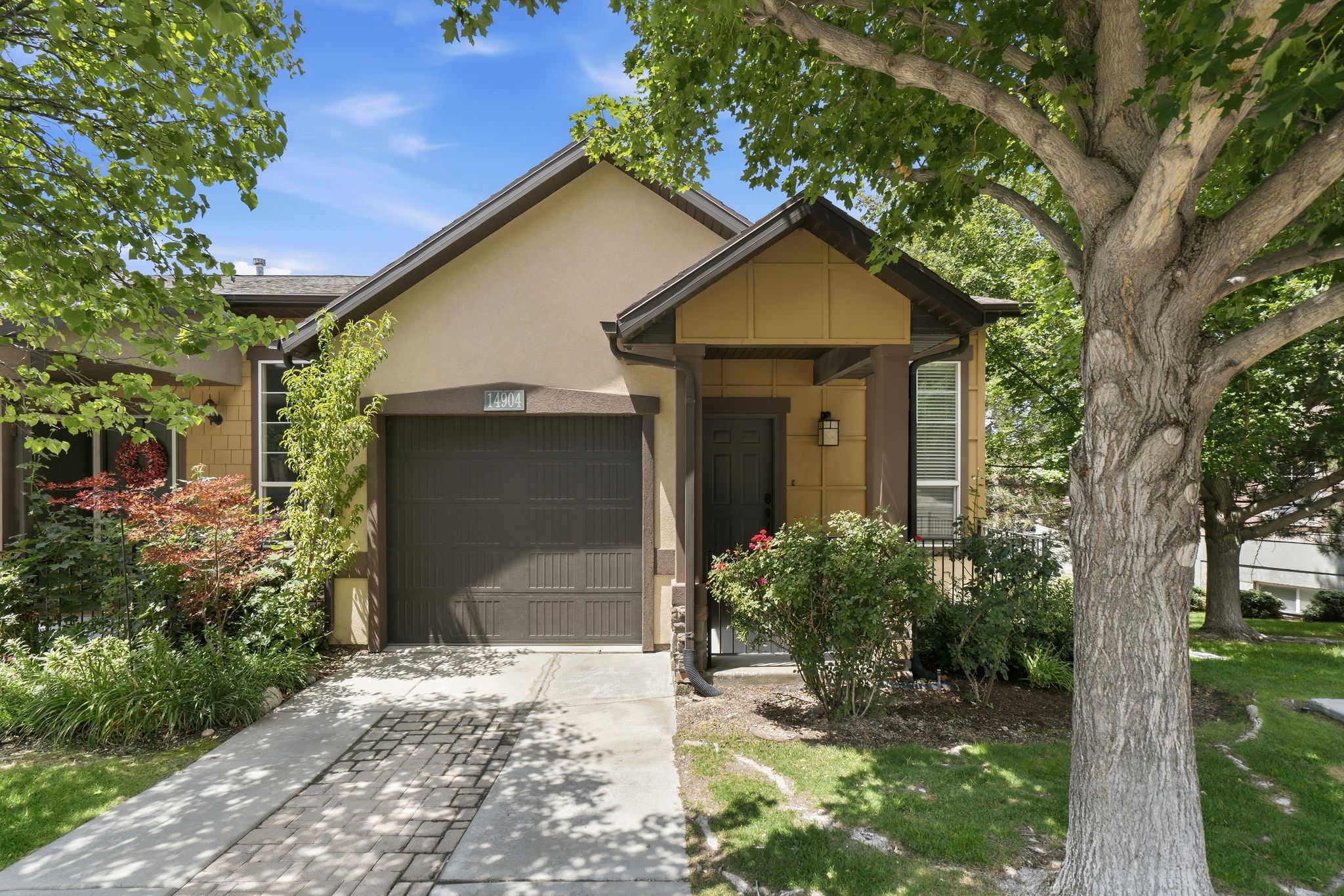 Single-story residence featuring a two-tone stucco exterior with dark trim