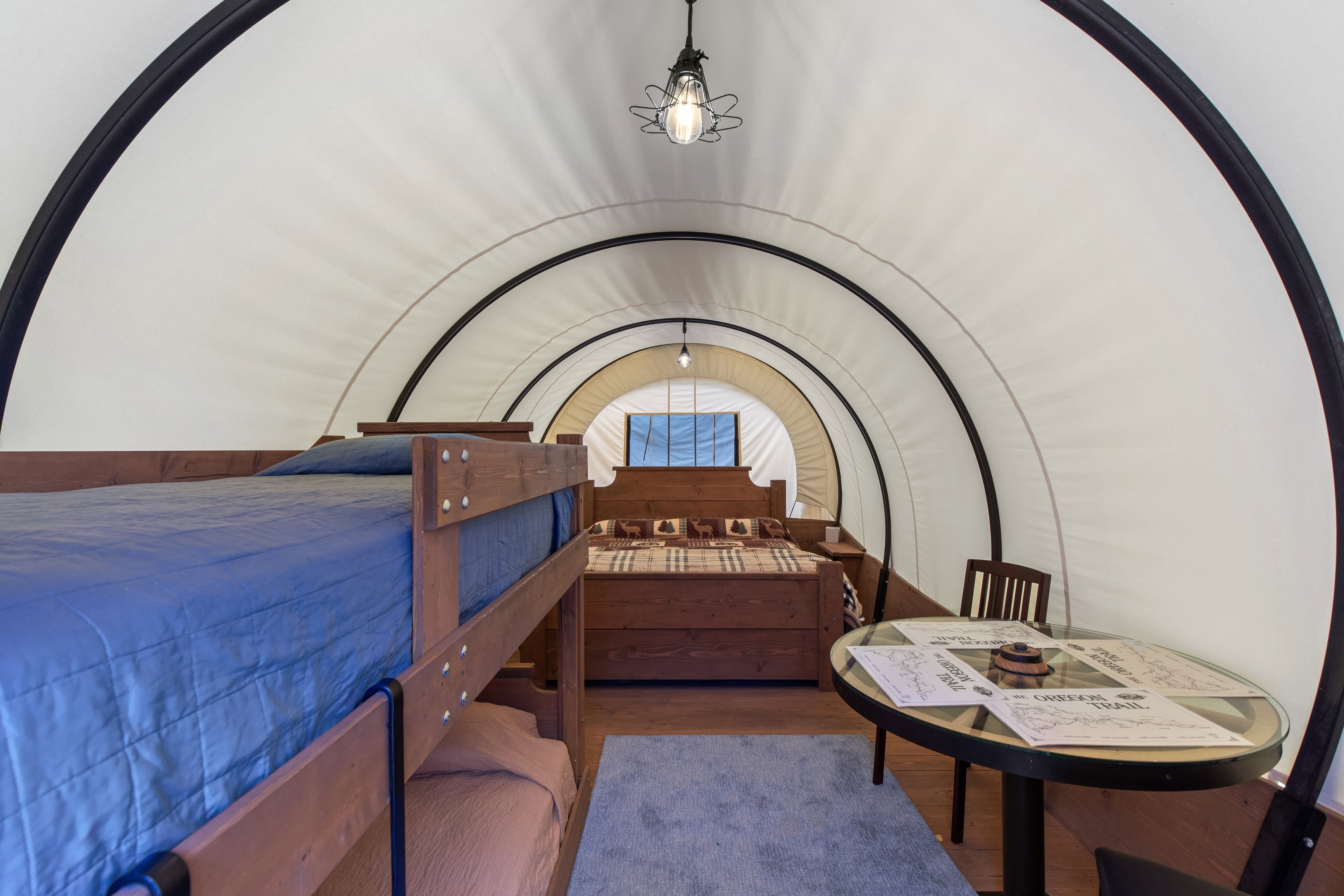 Arched interior with a white fabric ceiling and dark structural ribs