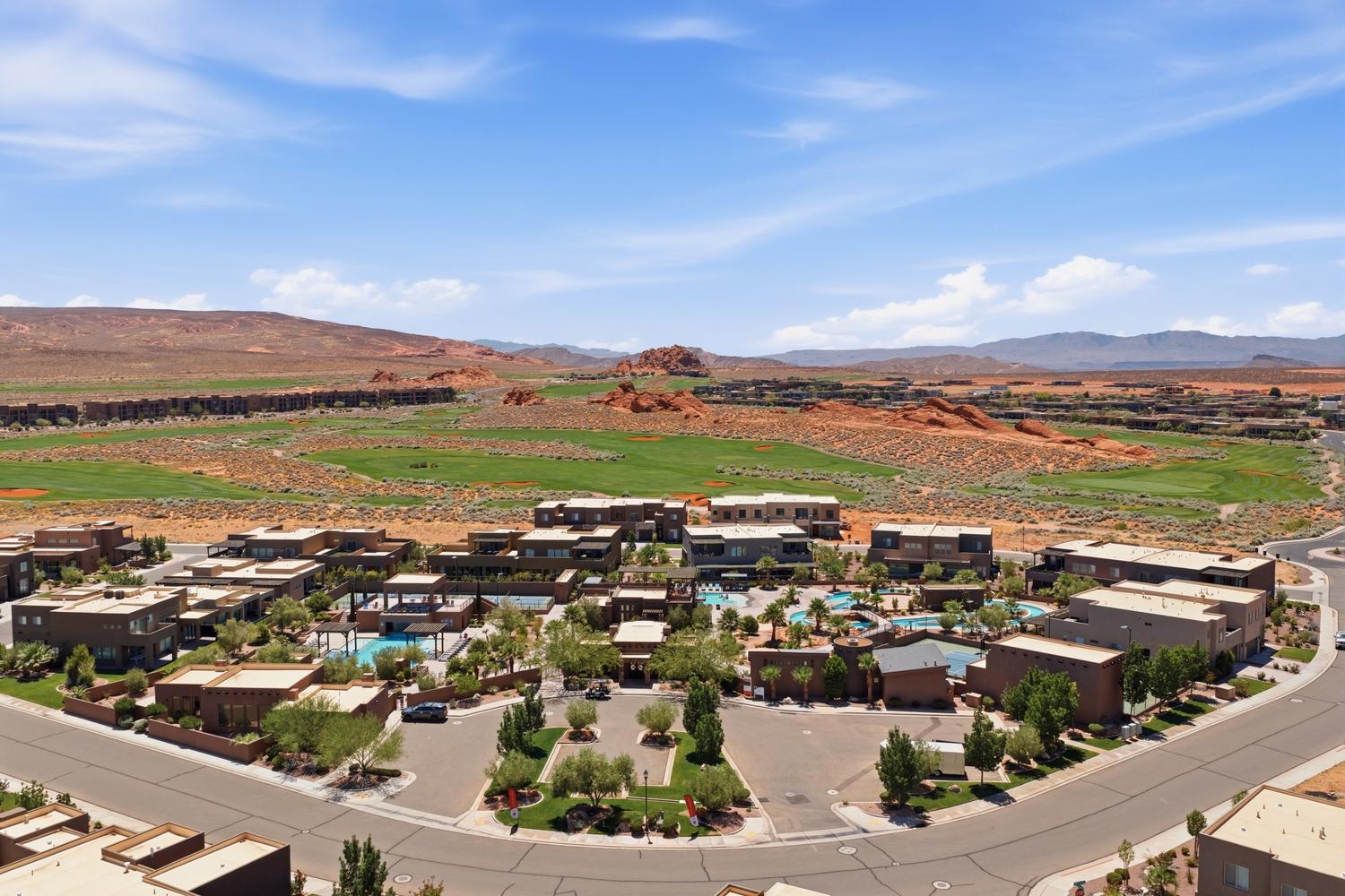 Modern desert community featuring multi-story residences with flat roofs and stucco exteriors