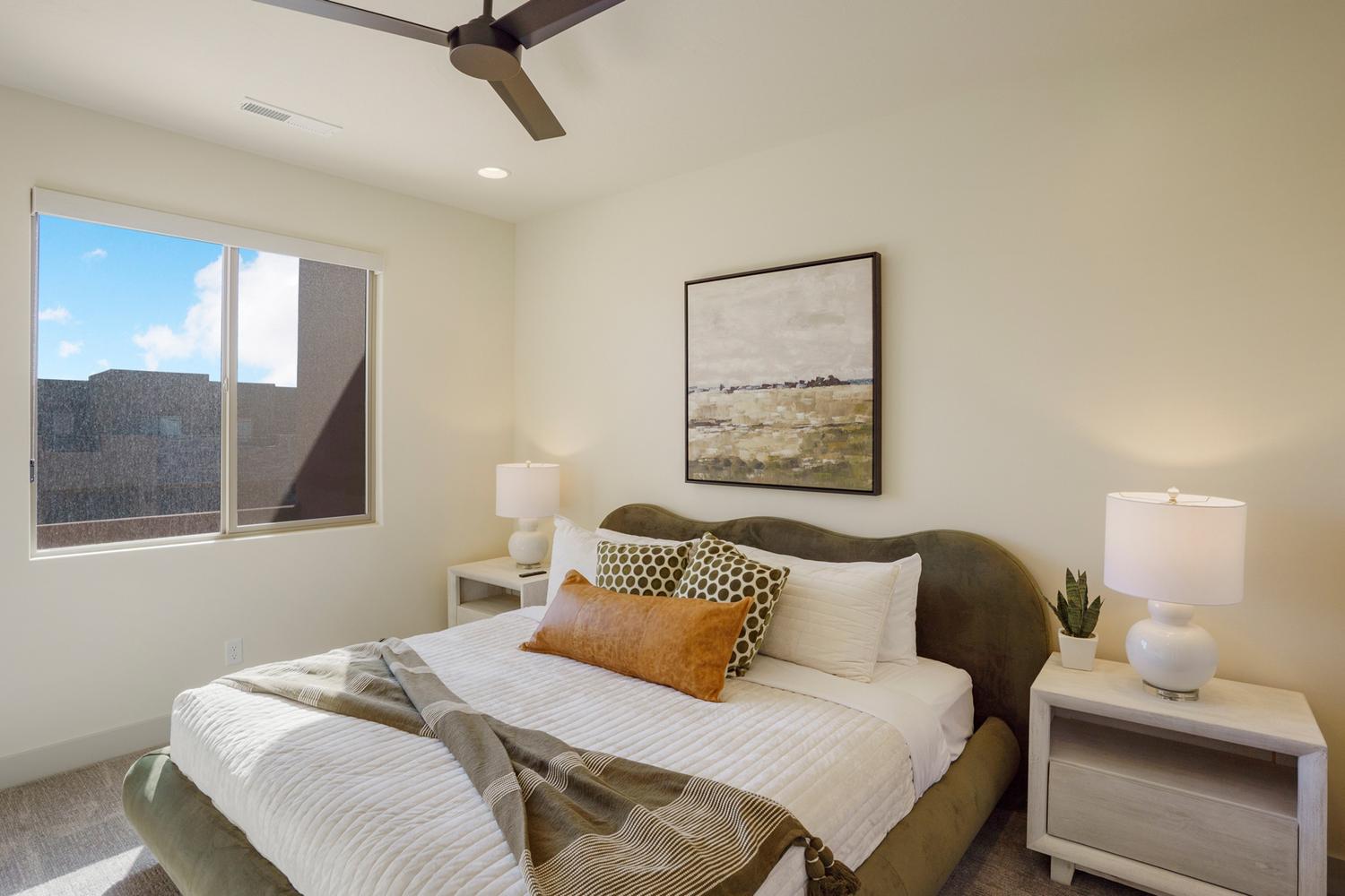 Bright bedroom featuring a large window, recessed lighting, and a contemporary ceiling fan