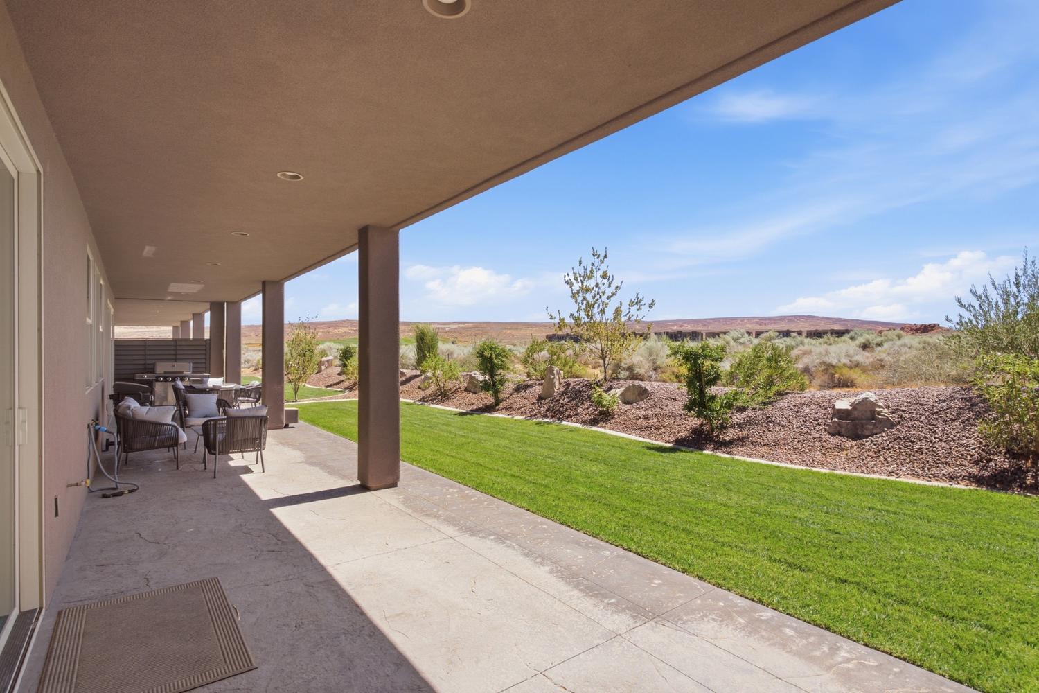 Covered patio with recessed lighting, concrete flooring, and an expansive lawn