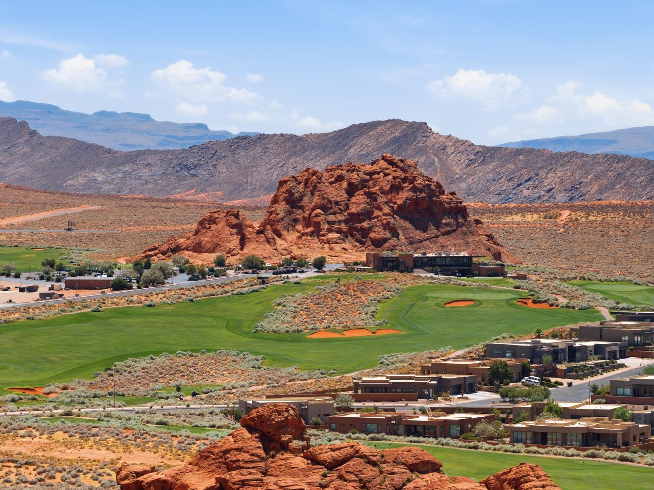 Expansive golf course setting featuring lush green fairways and sand traps