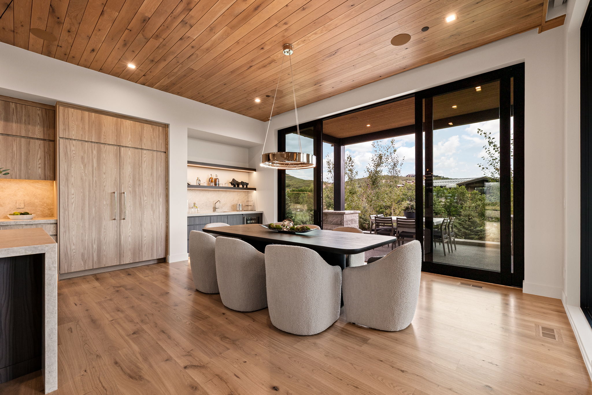 Dining area featuring a wood-panel ceiling, wide plank wood-finish flooring, and built-in cabinetry