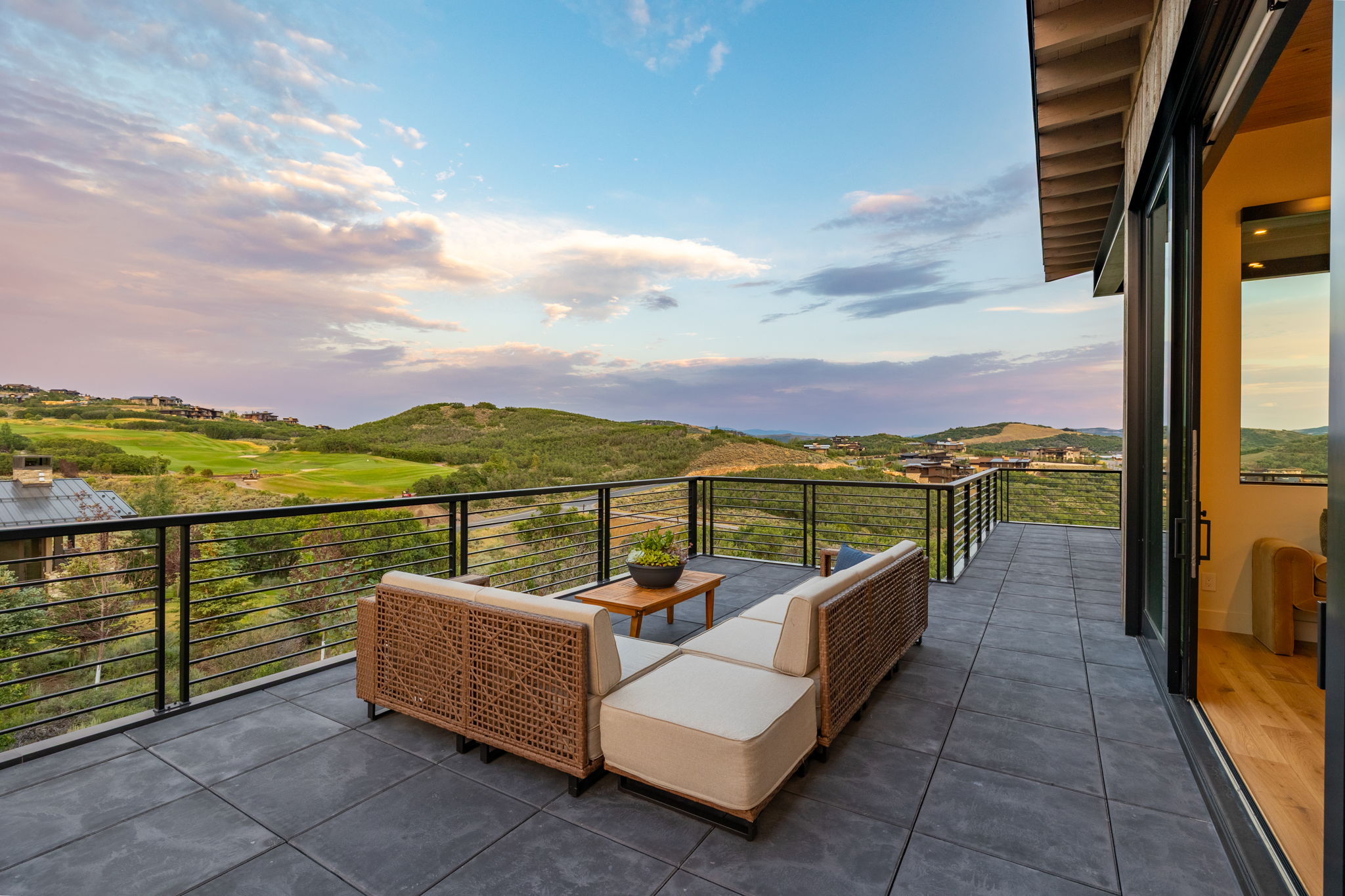 Spacious outdoor deck featuring large format tile flooring and contemporary cable railings