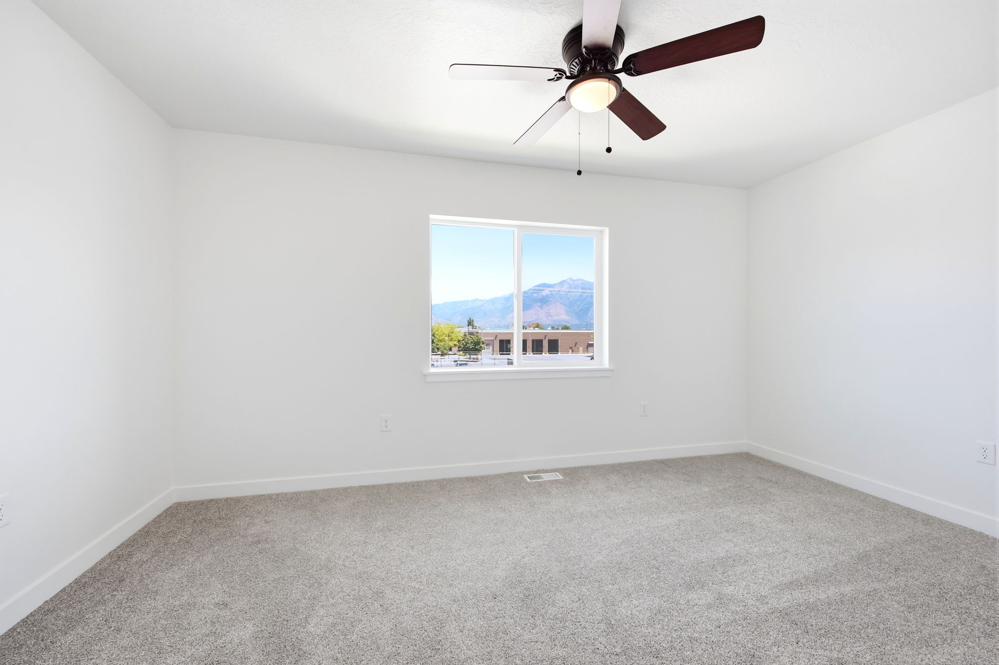 Bright room with plush gray carpeting and white walls