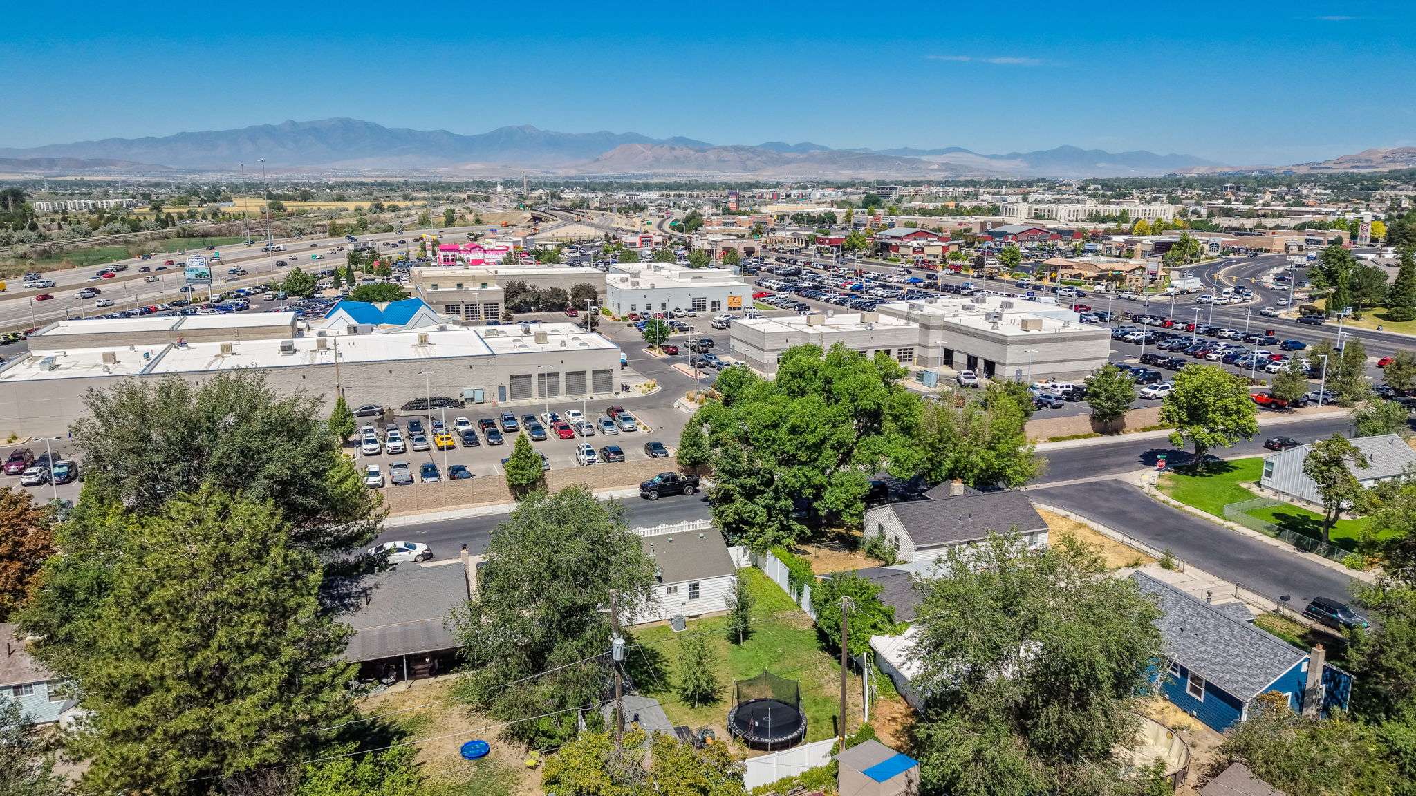 Aerial perspective showcasing a residential area interspersed with commercial buildings and roadways