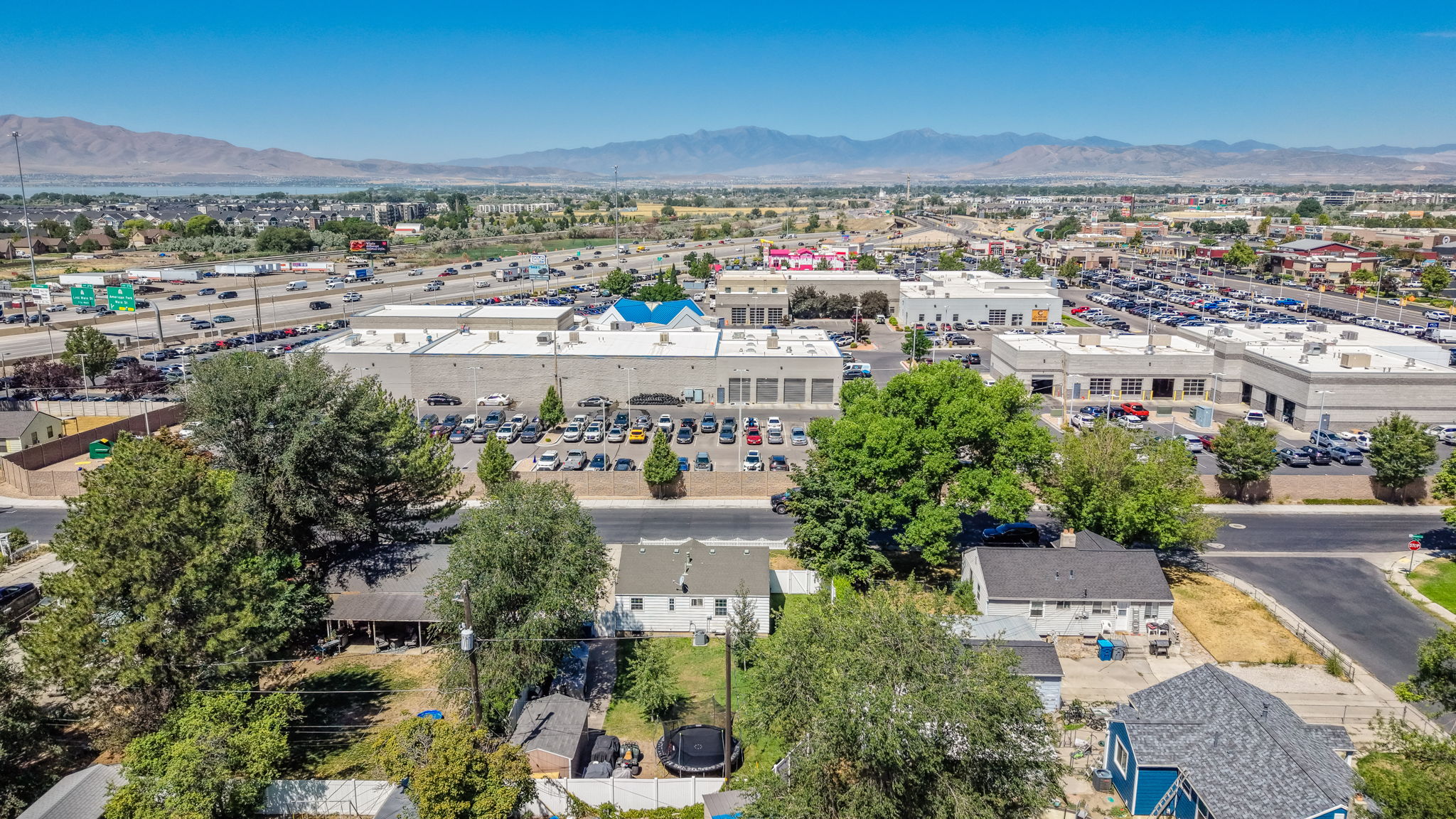 Aerial perspective showcasing multiple commercial buildings and residential properties