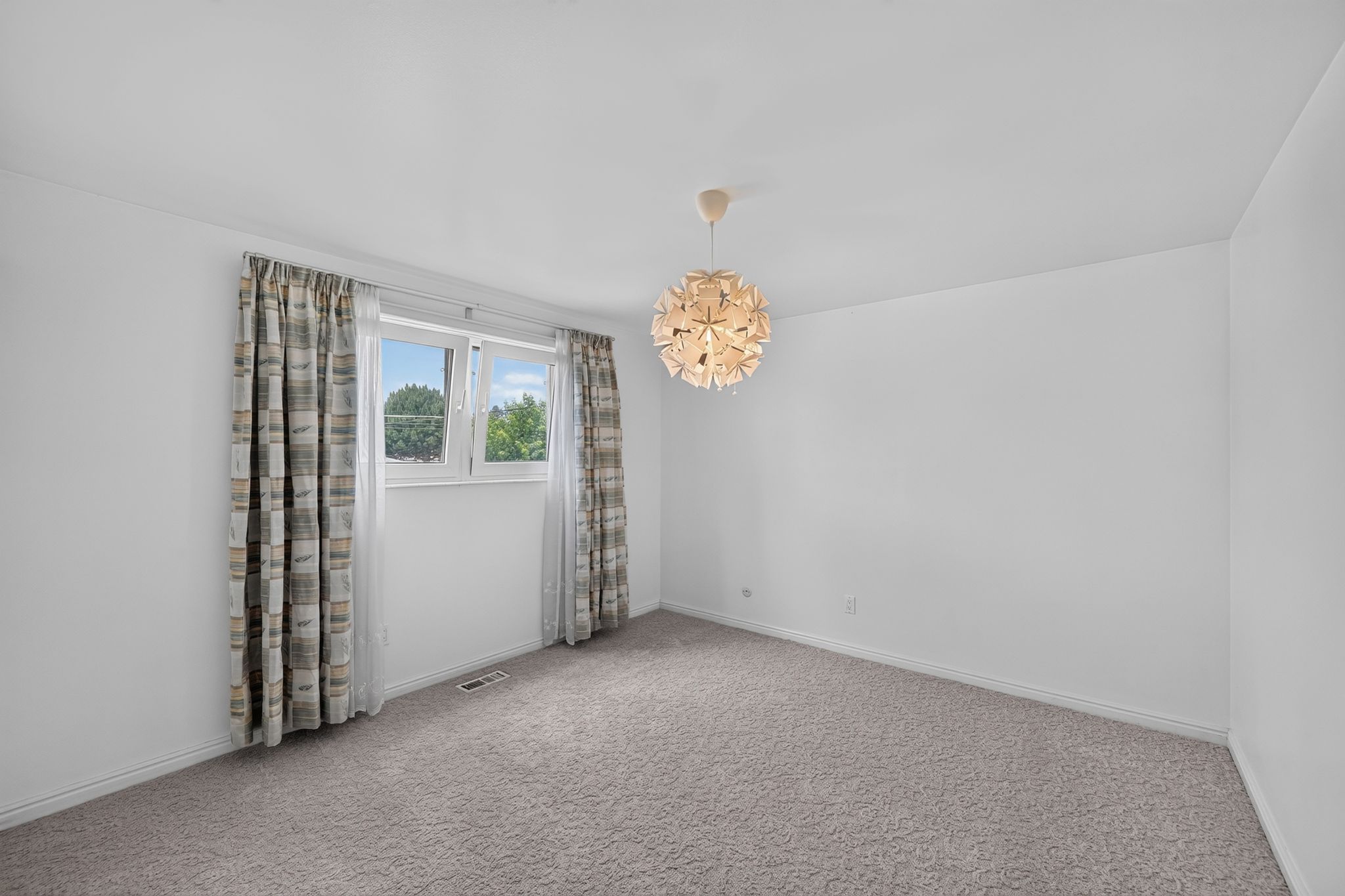 Light gray carpeting throughout, featuring white walls and baseboards