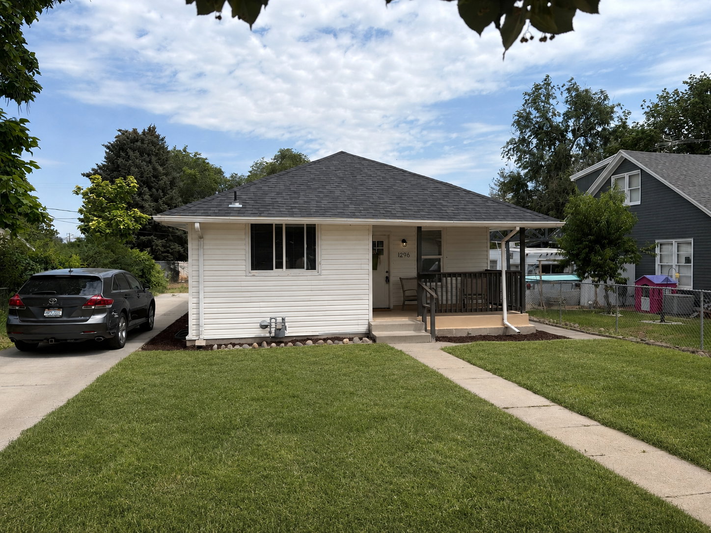 White siding exterior with a dark shingle roof