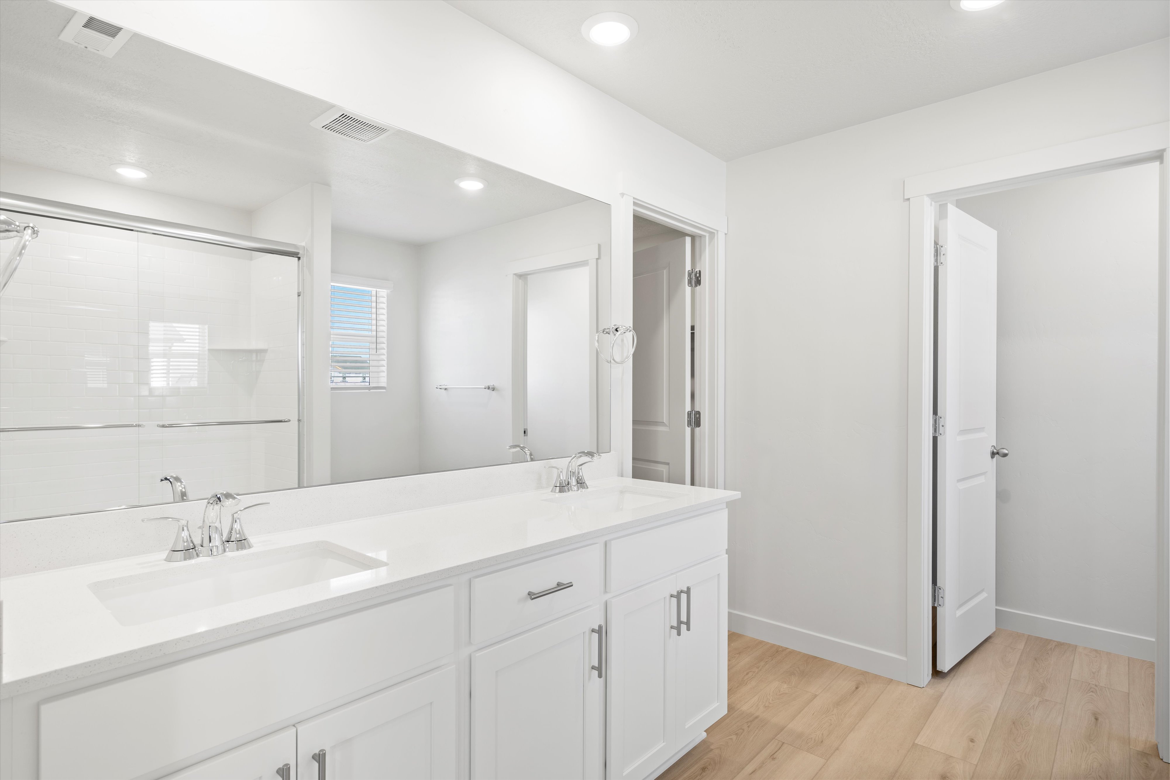 Double vanity with integrated sinks and chrome fixtures