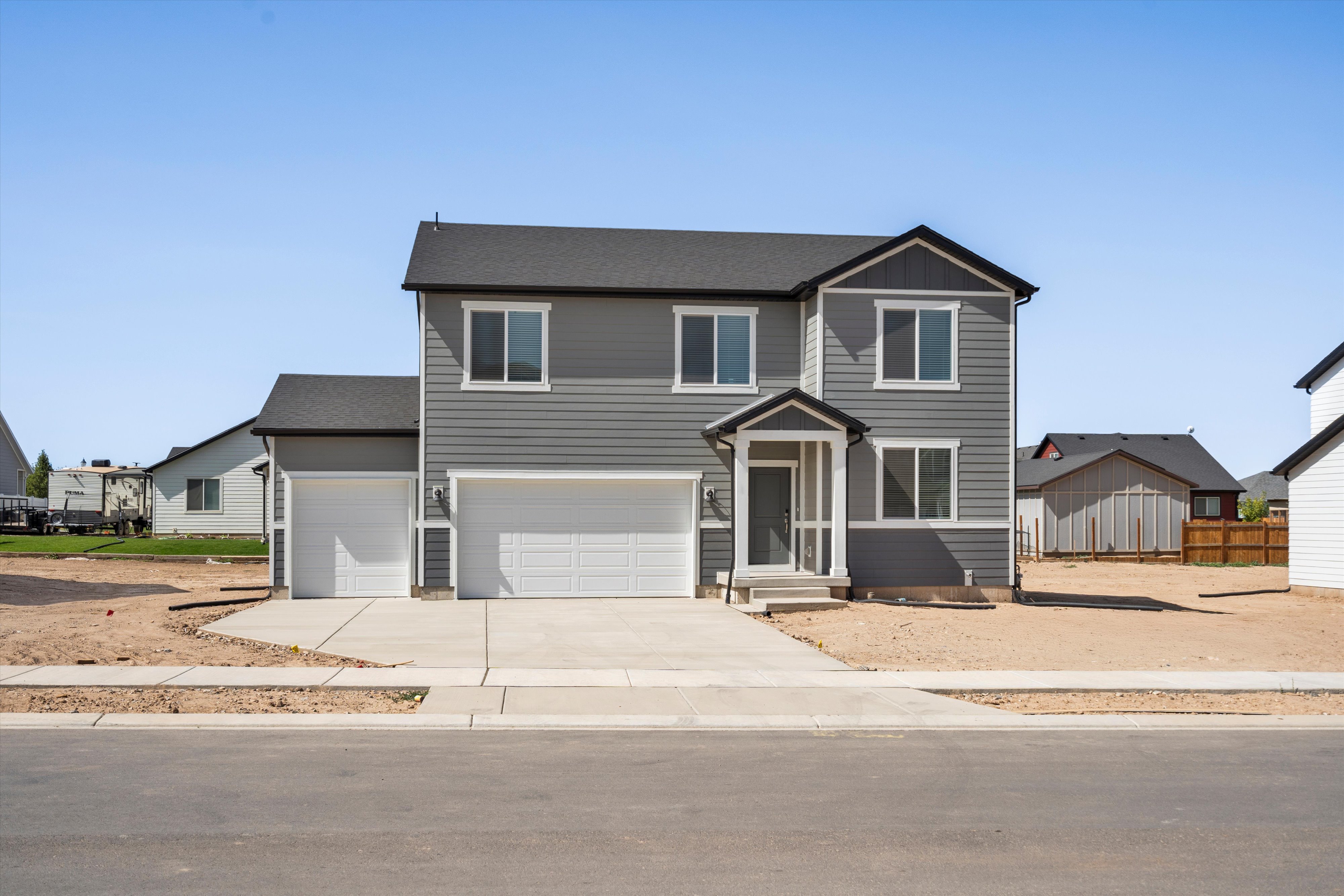 Two-story residence featuring gray horizontal siding and black trim accents