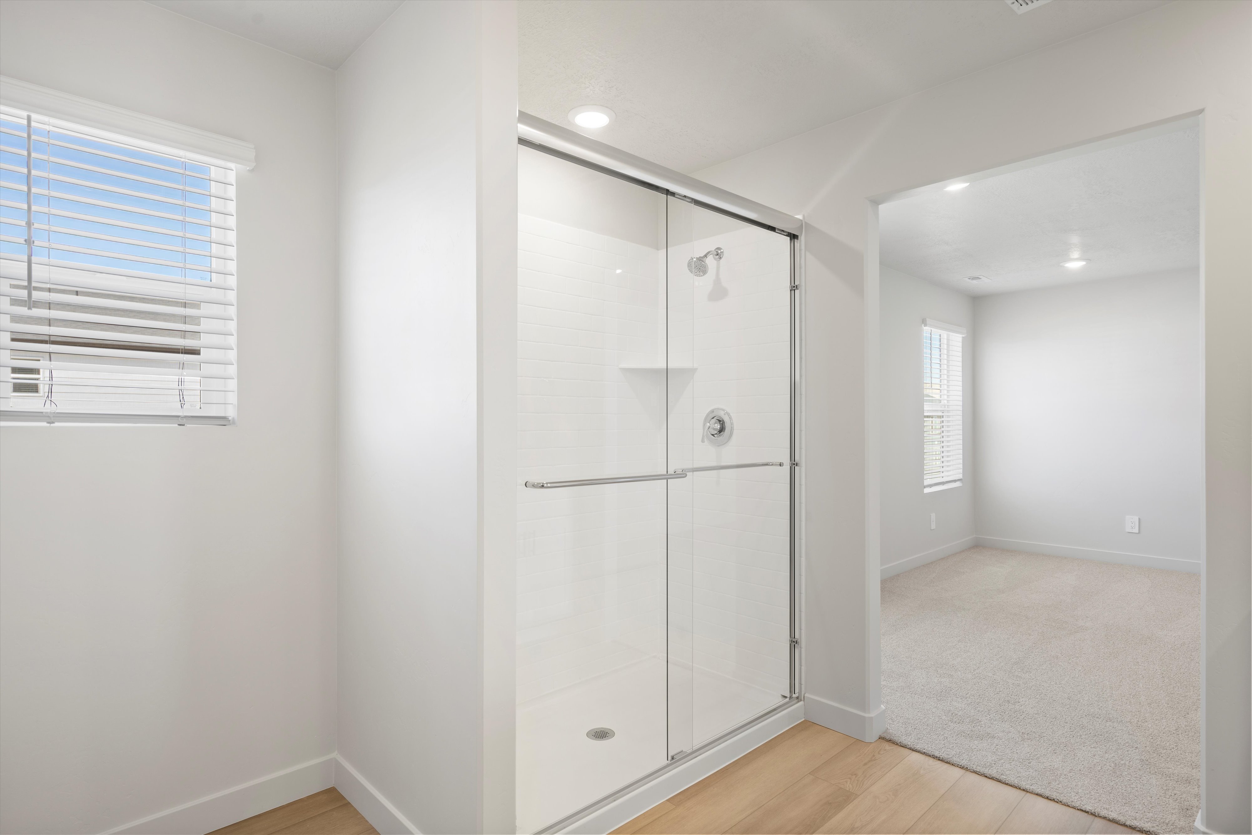 Shower enclosure with clear glass doors and chrome hardware