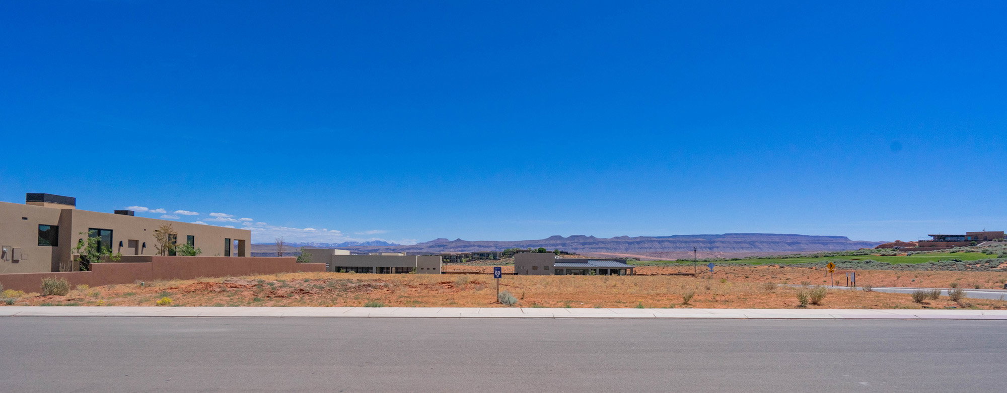 Expansive undeveloped lot featuring a flat grade and clear sky