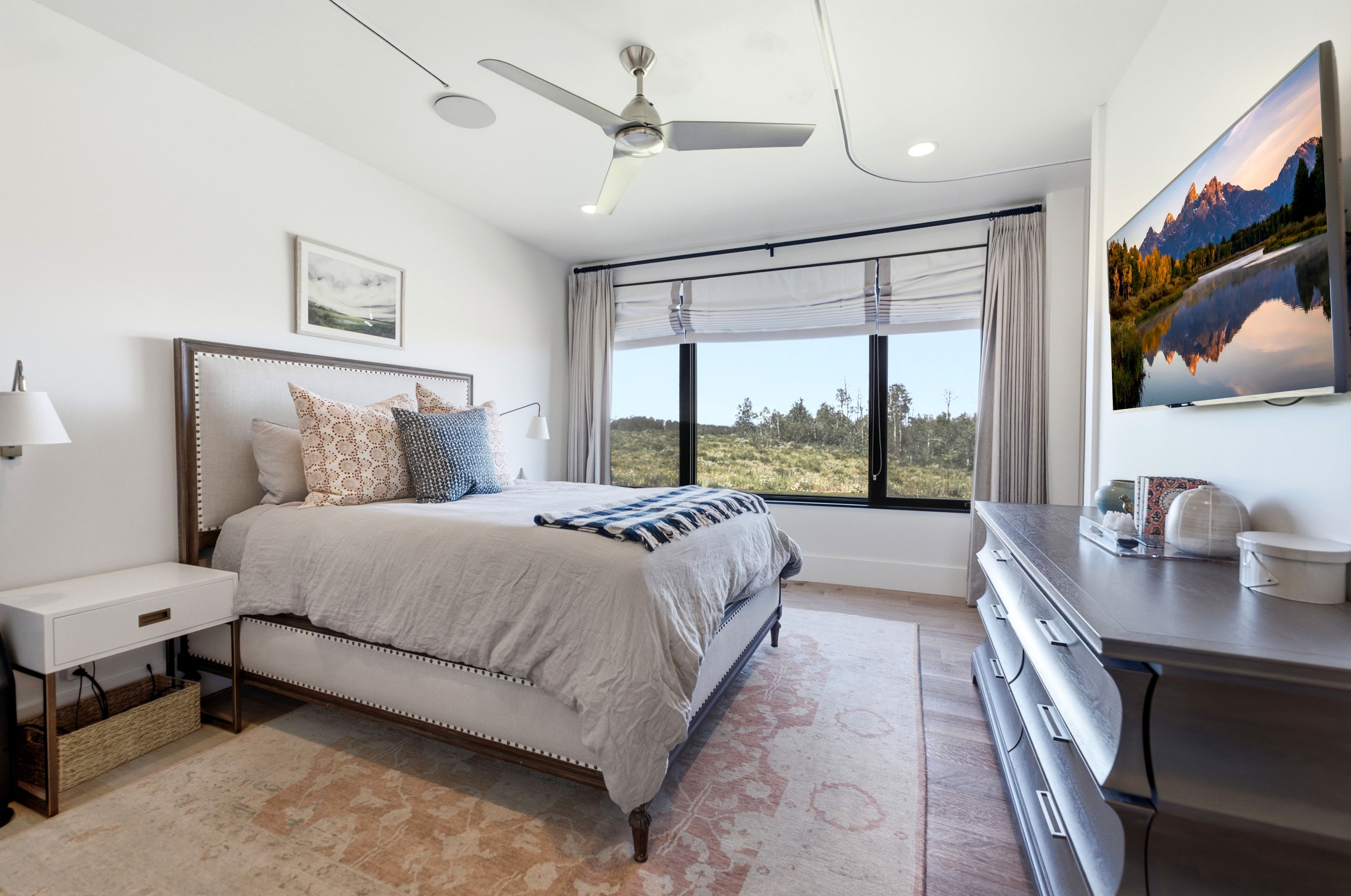 Bedroom featuring a large window, recessed lighting, and a ceiling fan