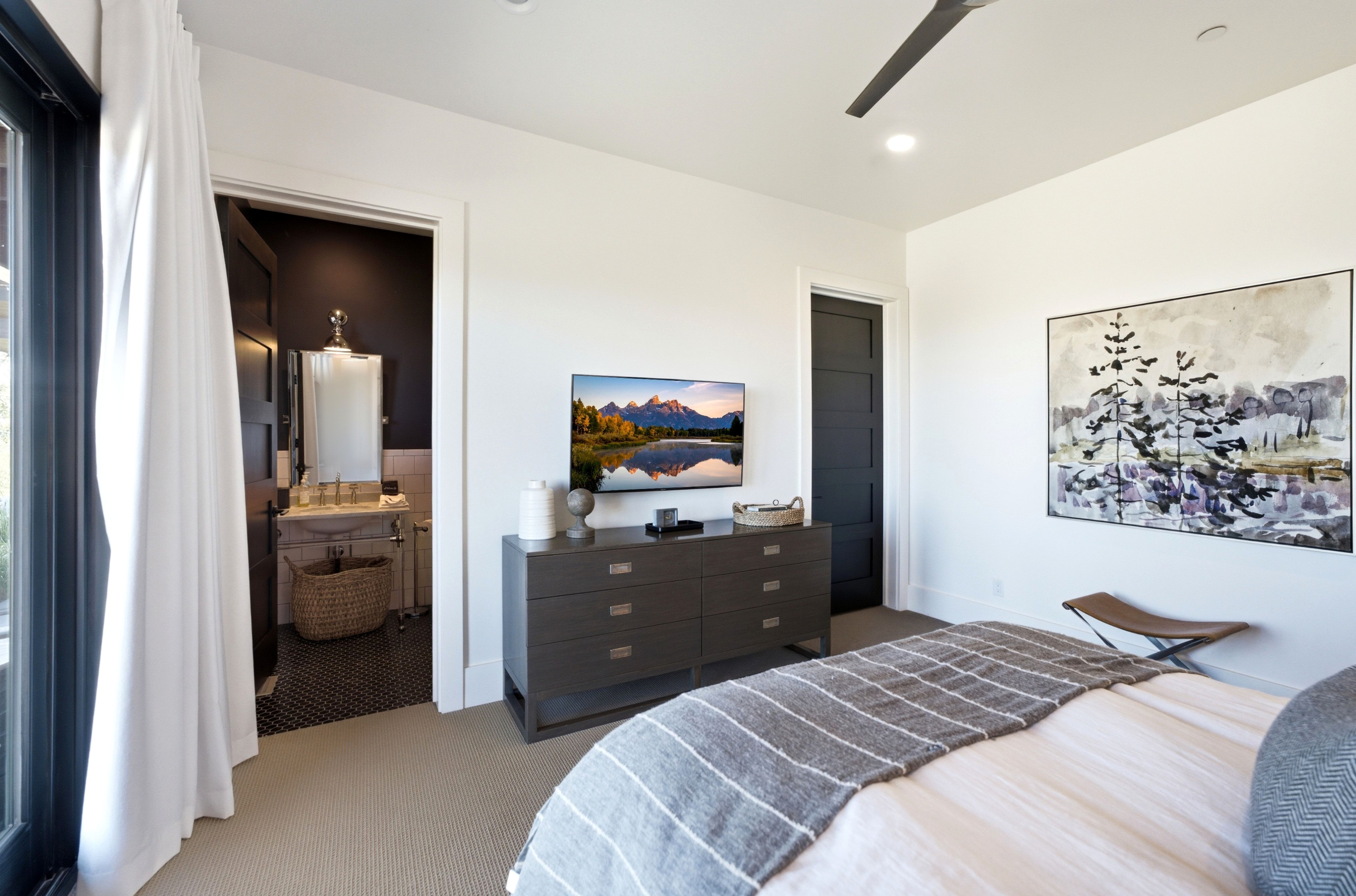 Bedroom featuring a ceiling fan, recessed lighting, and an entryway to a bathroom with a pedestal sink and hex tile flooring